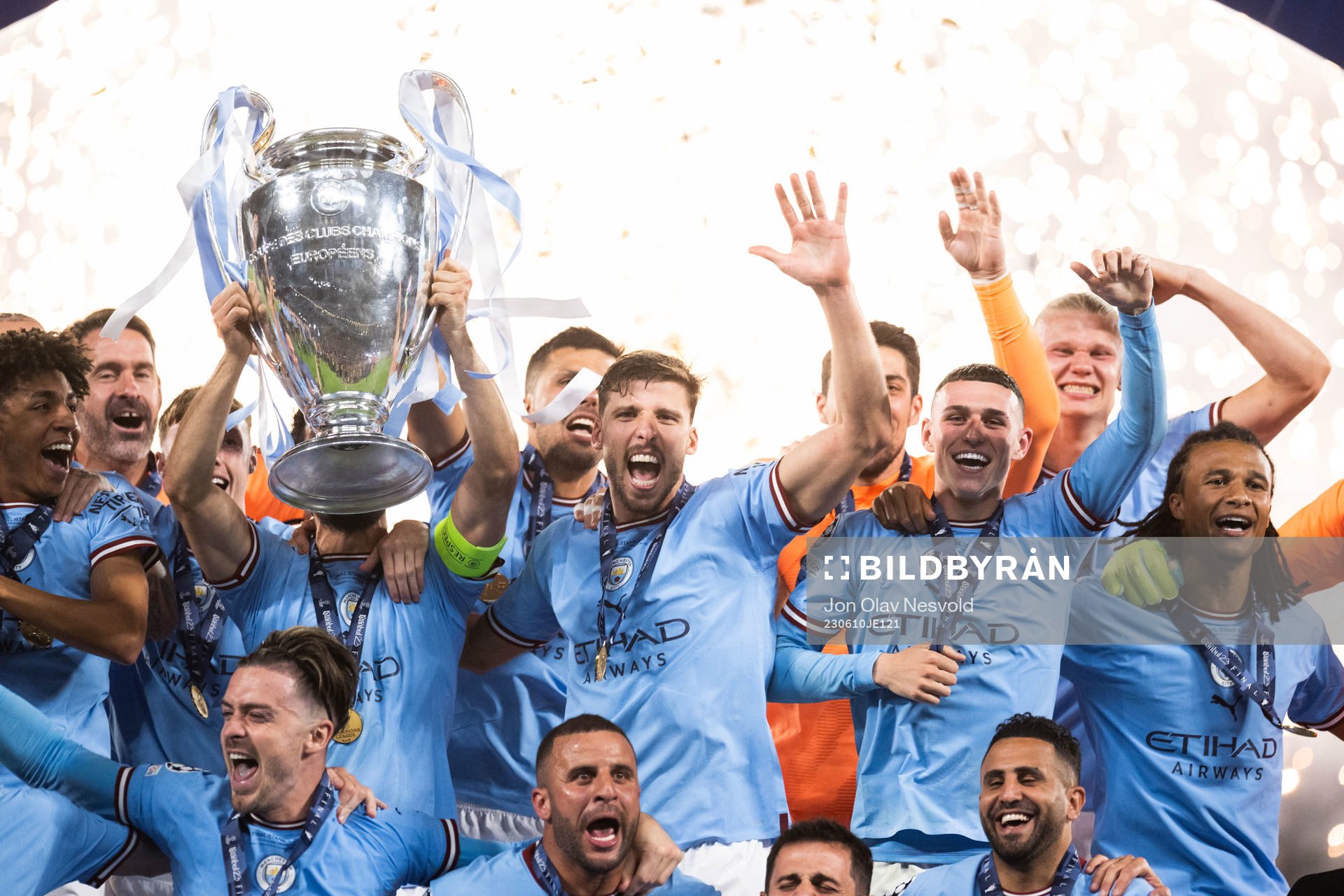 Players of Manchester City celebrate with the trophy