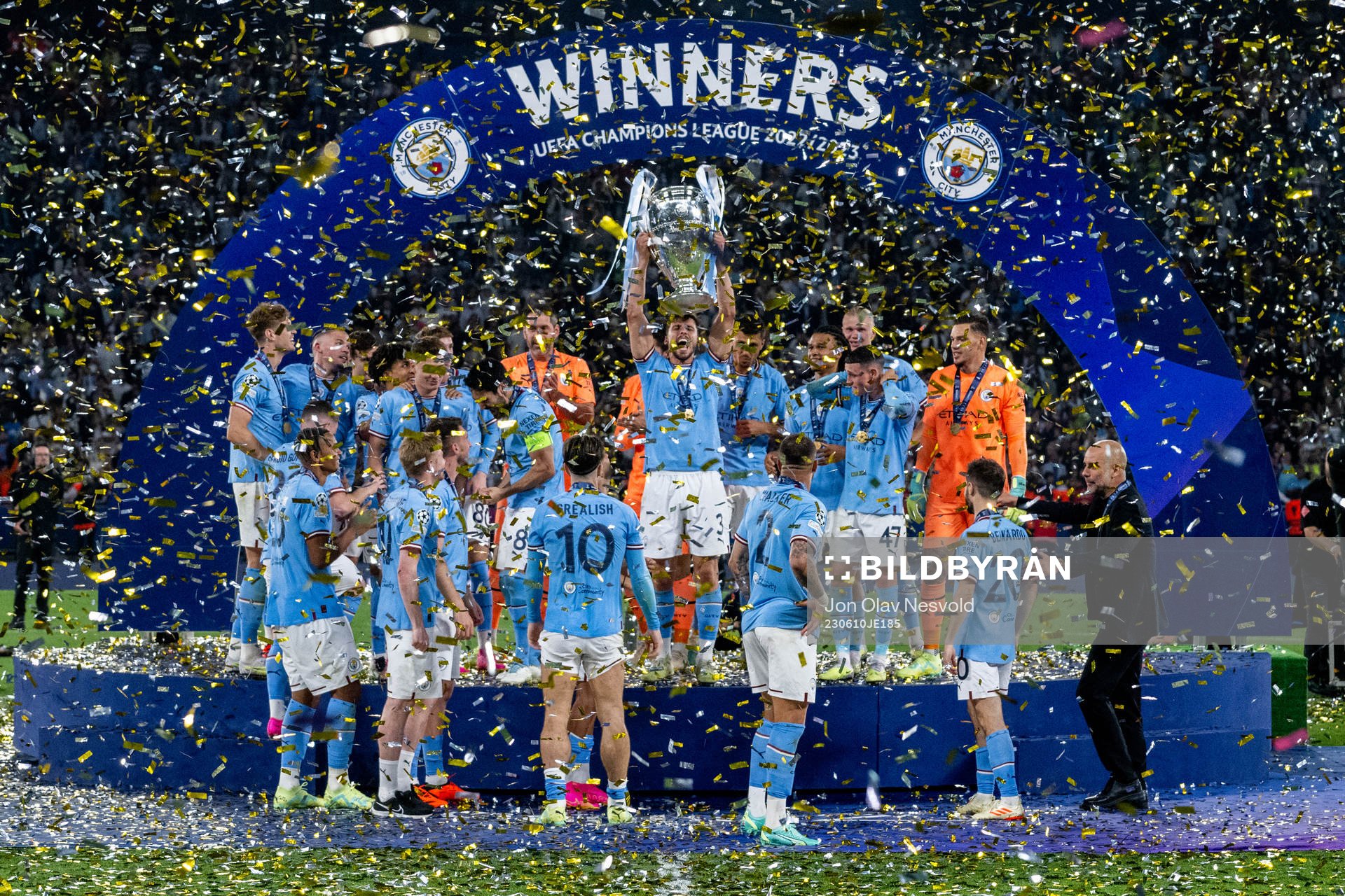 Players of Manchester City celebrate with the trophy
