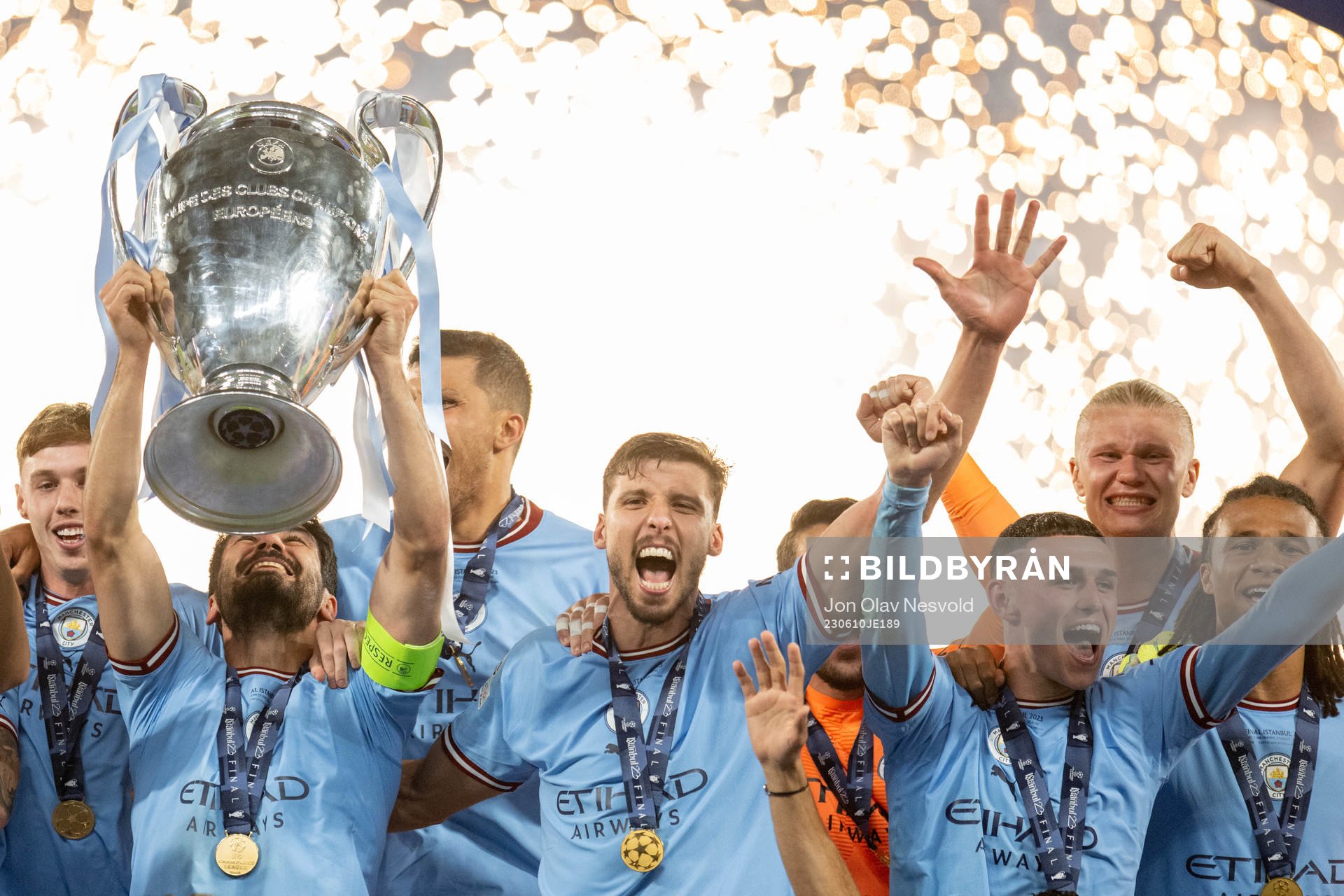 Players of Manchester City celebrate with the trophy
