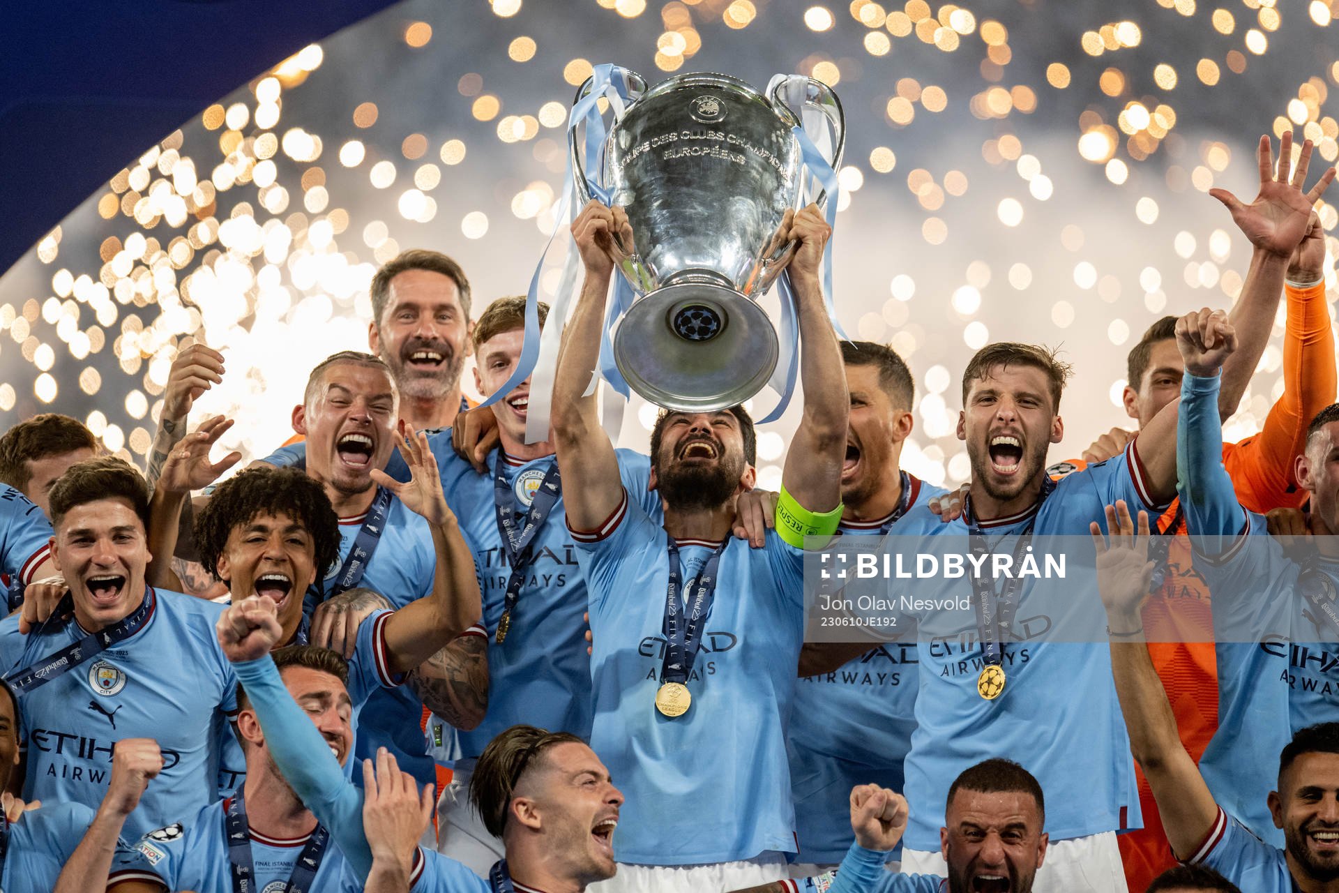 Players of Manchester City celebrate with the trophy