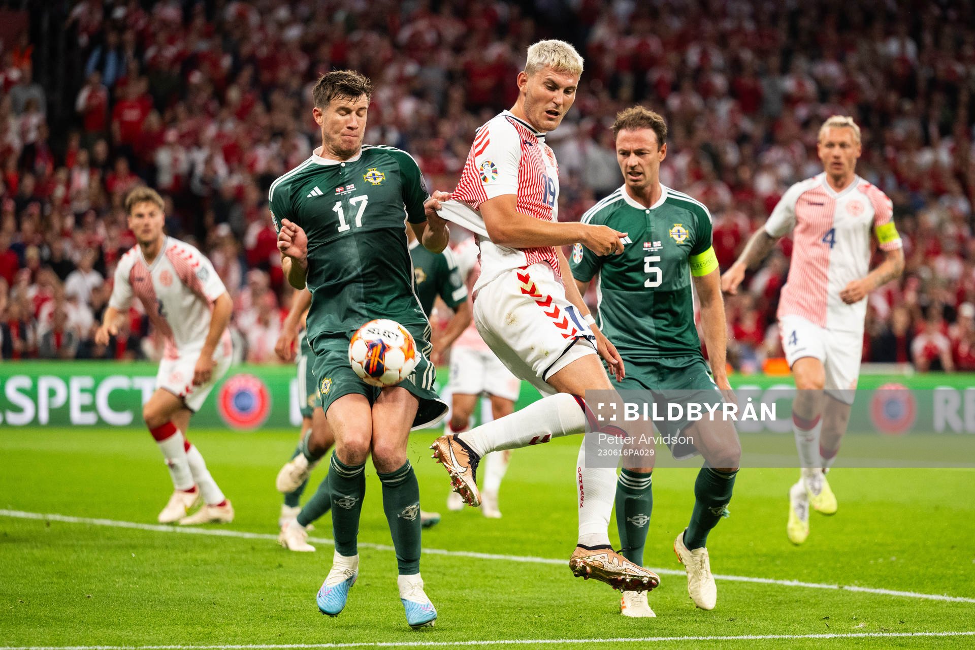 Jonas Wind of Denmark against Paddy McNair and Jonny Evans