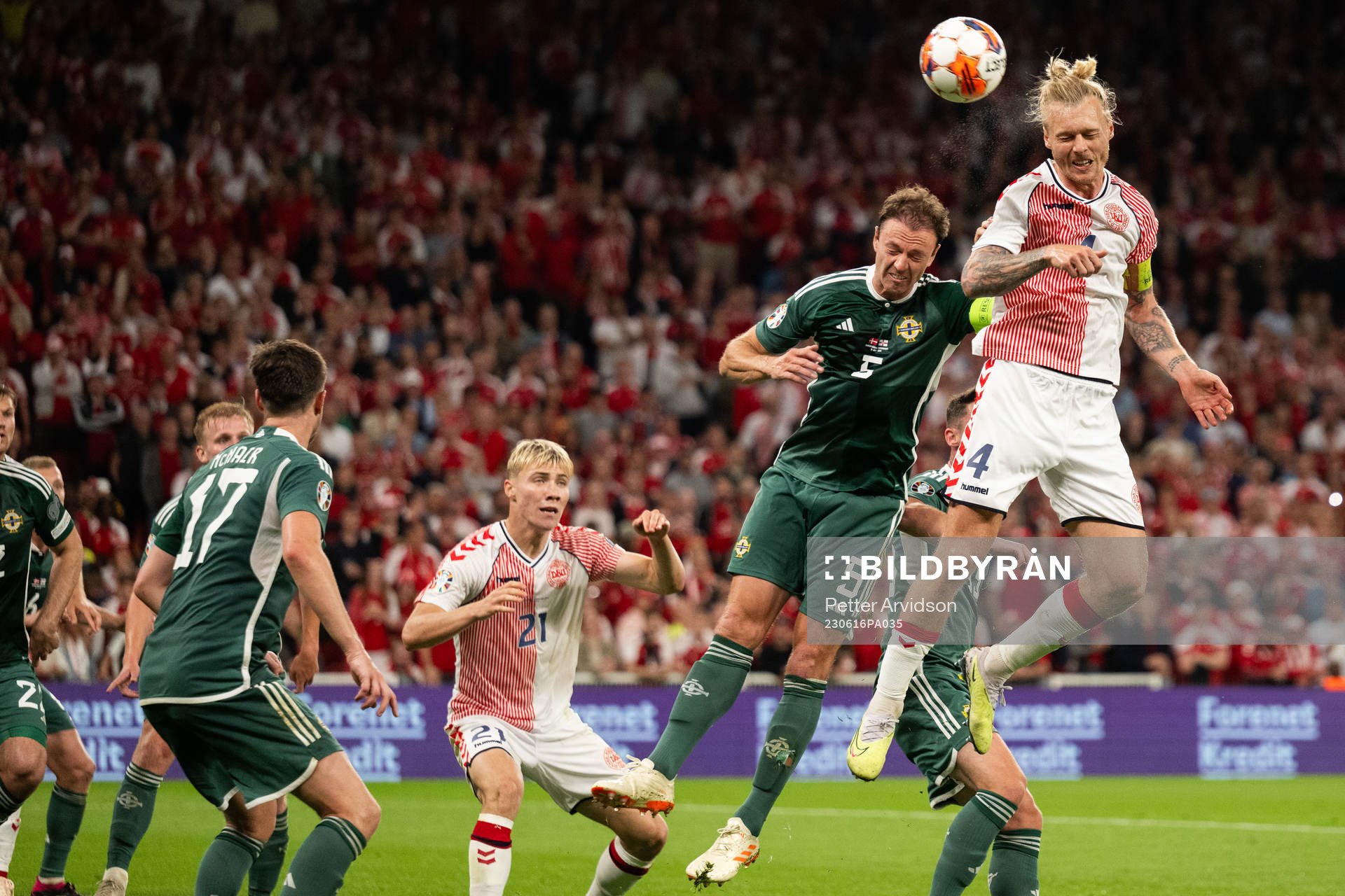 Jonny Evans of Northern Ireland and Simon Kjær of Denmark