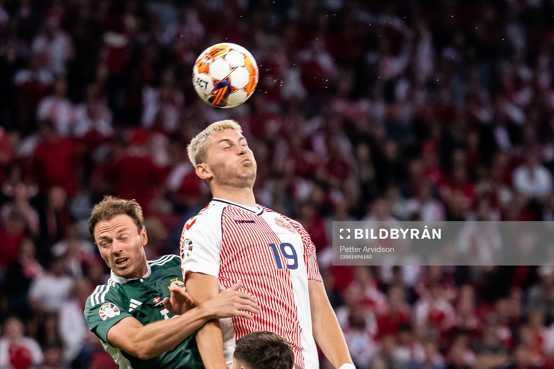 Jonny Evans of Northern Ireland and Jonas Wind of Denmark