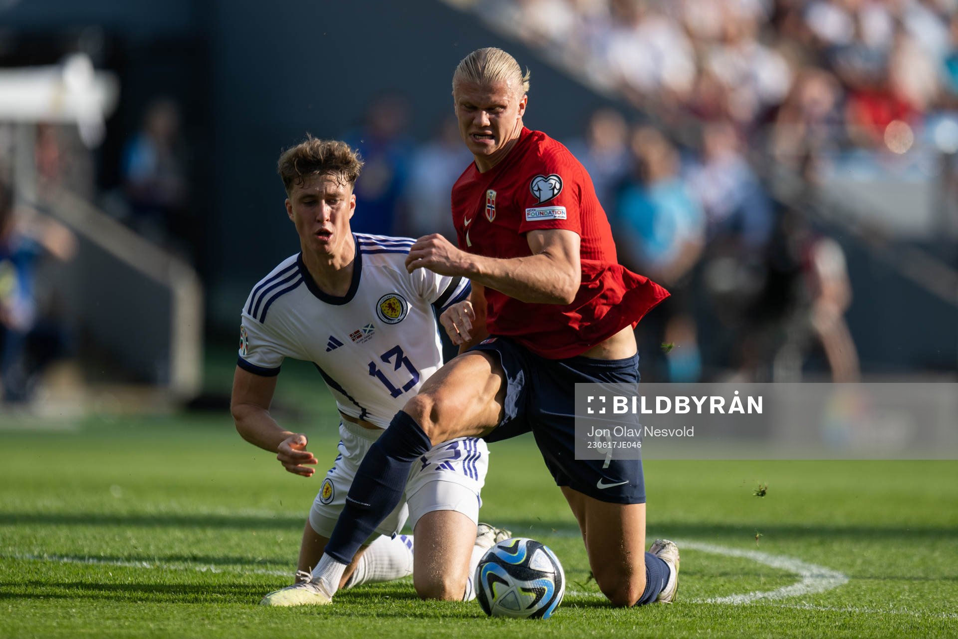 Jack Hendry of Scotland and Erling Braut Haaland of Norway