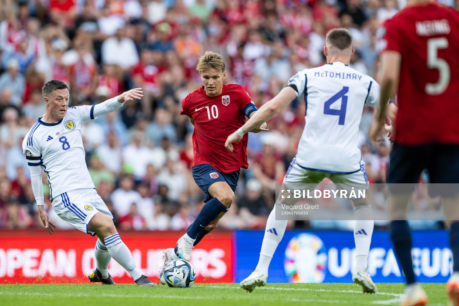 Callum McGregor of Scotland and Martin Ødegaard of Norway