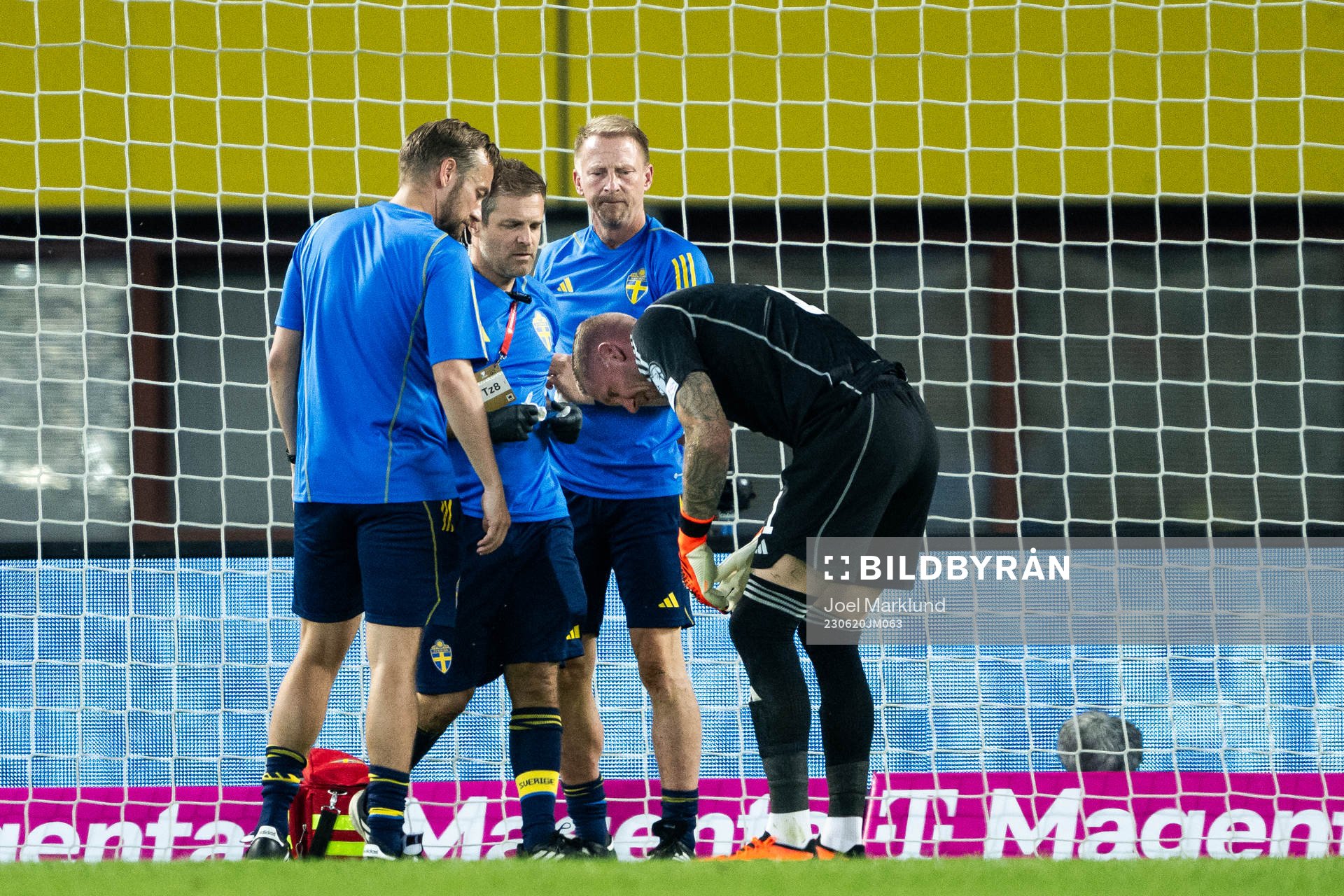 Goalkeeper Robin Olsen of Sweden receives medical attention