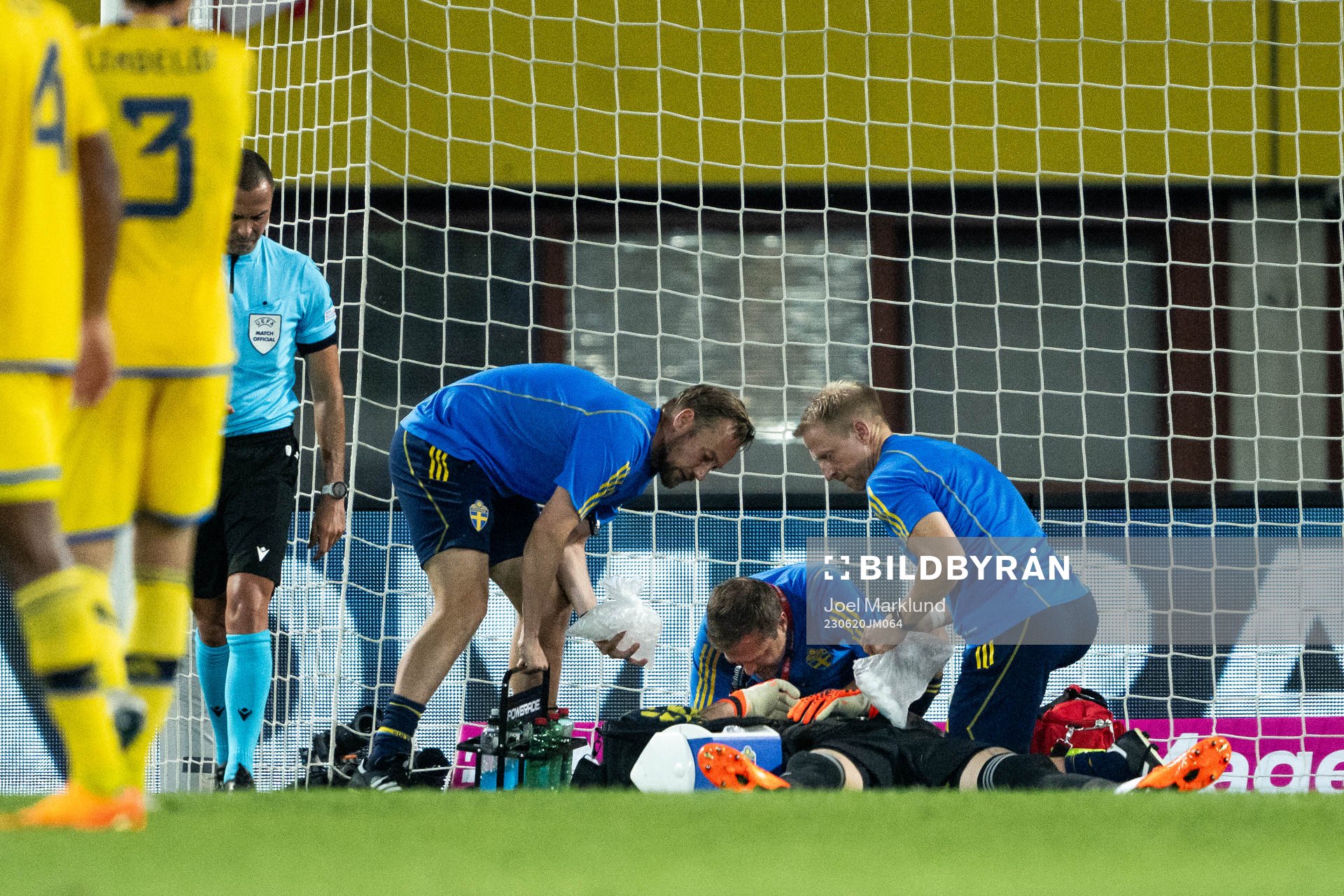 Goalkeeper Robin Olsen of Sweden receives medical attention