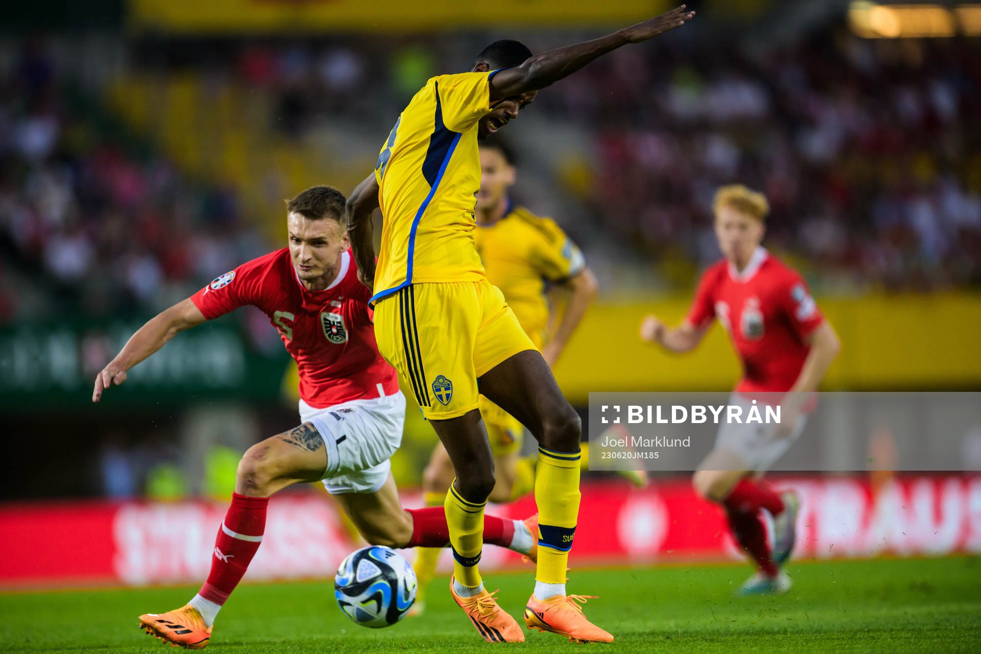 Stefan Posch of Austria trips Alexander Isak of Sweden