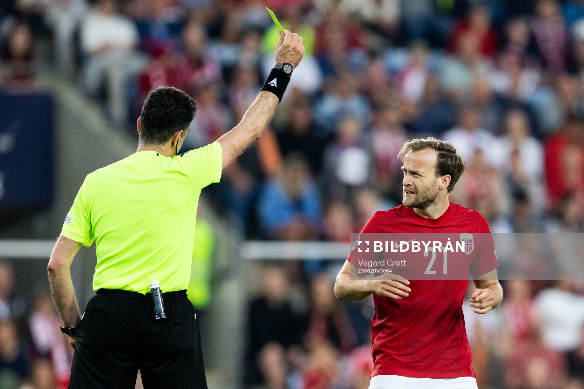 Bård Finne of Norway receives a yellow card from Referee