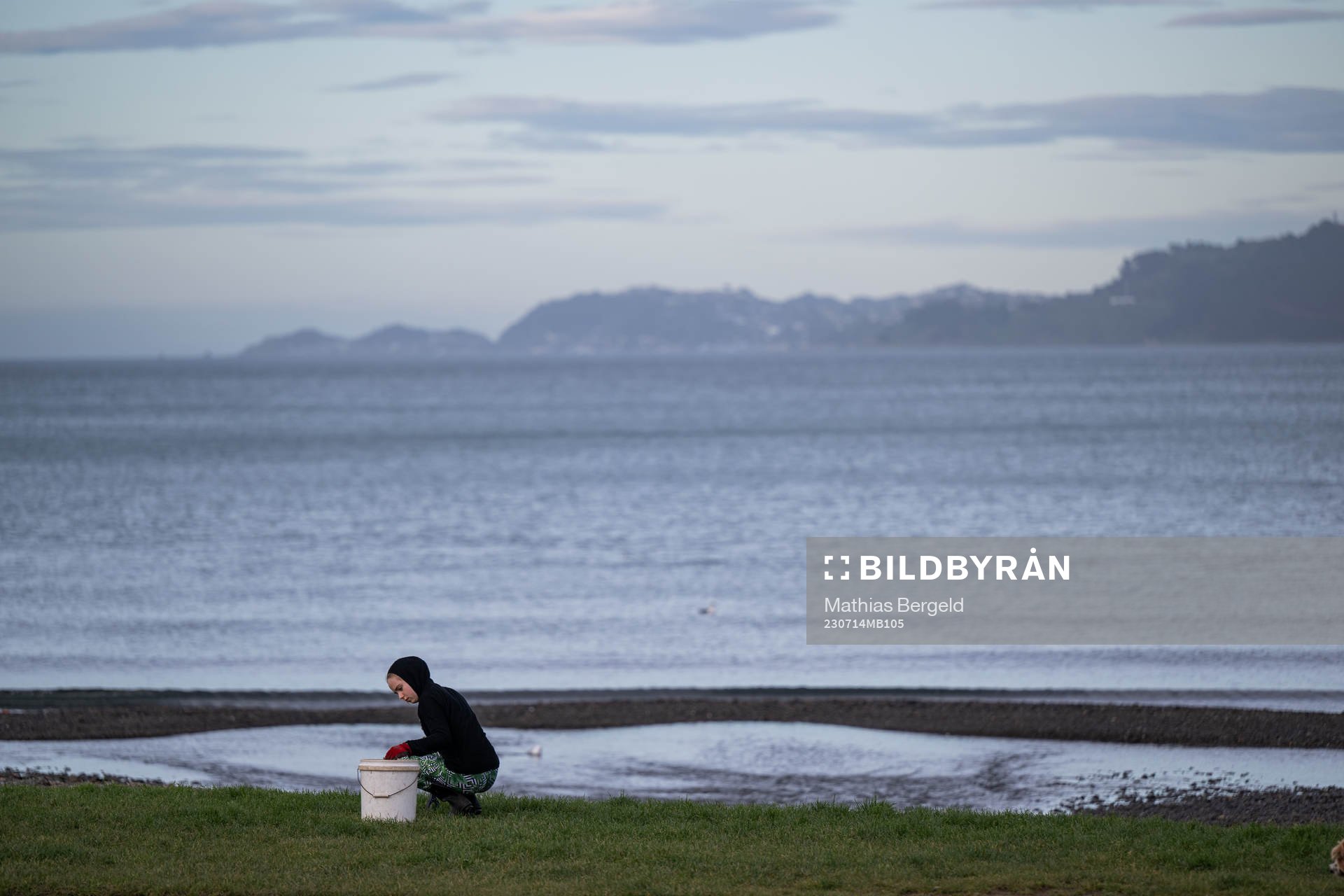 A woman cleans Petone Beach