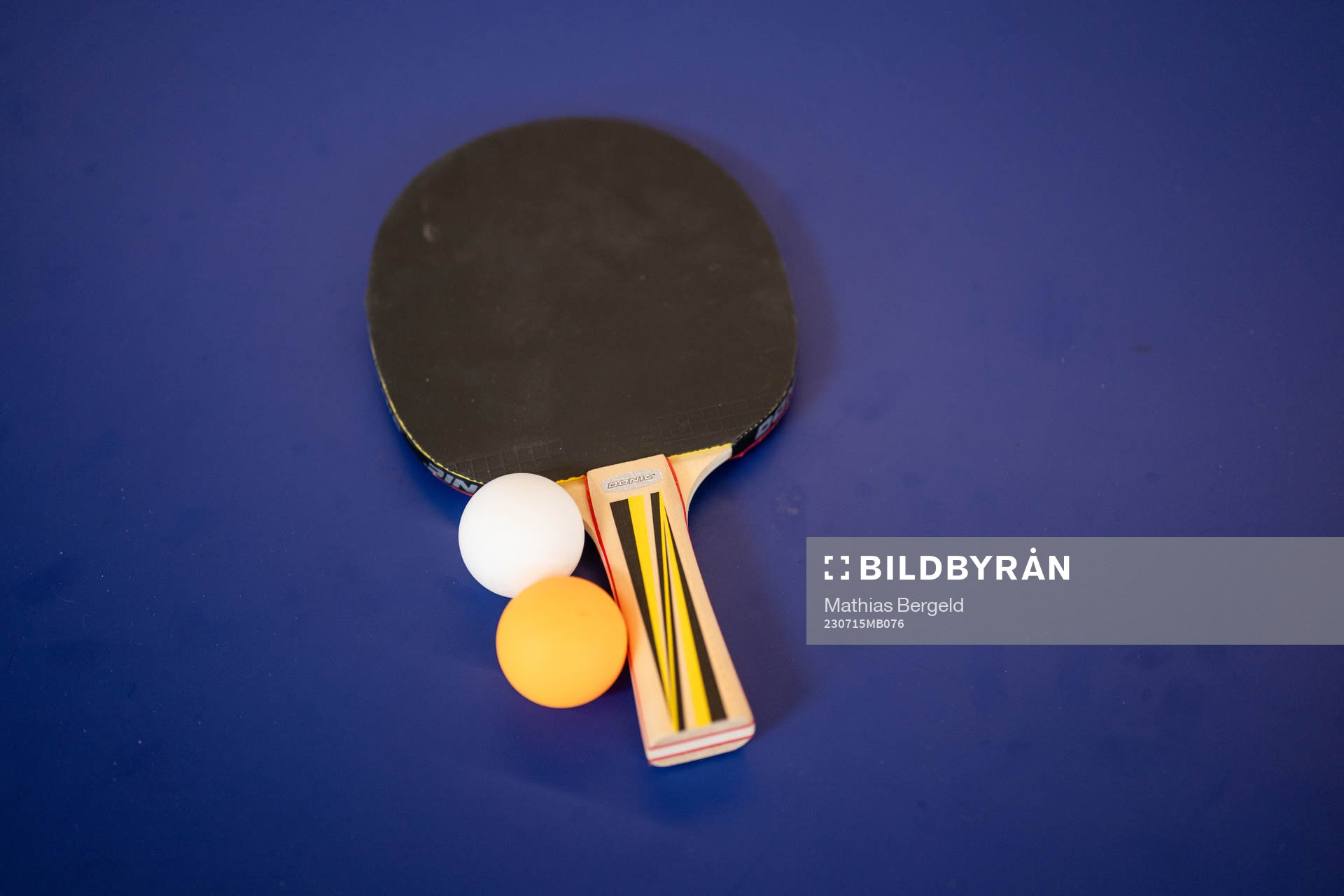A table tennis racket and balls