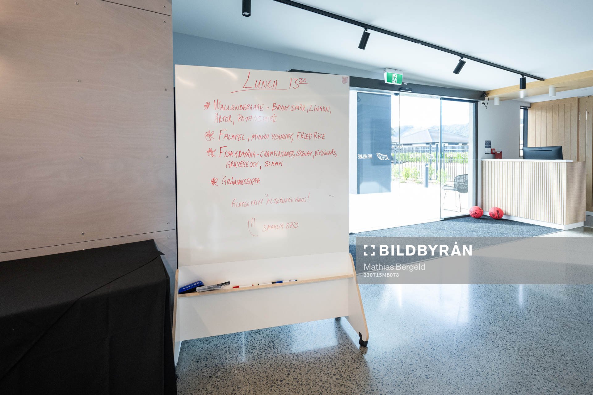 A white board which shows lunch dishes