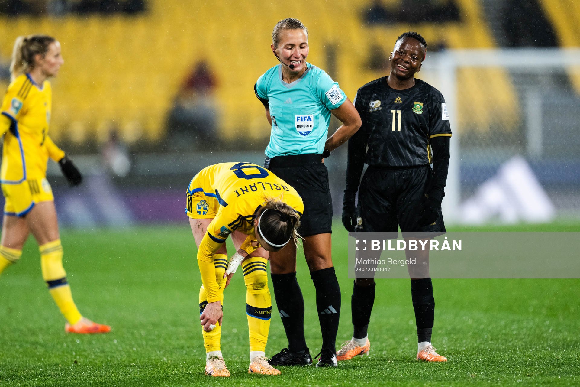 Kosovare Asllani of Sweden, referee Ekaterina Koroleva and