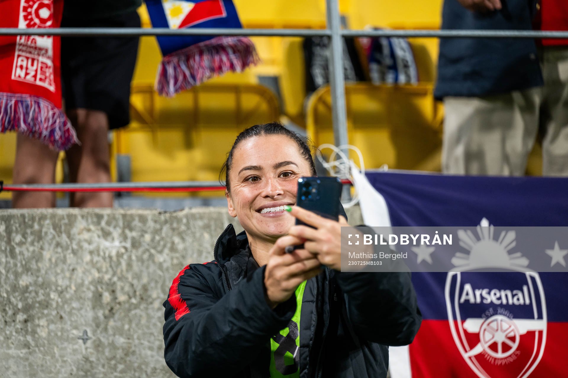 Ali Riley of New Zealand takes pictures with spectators