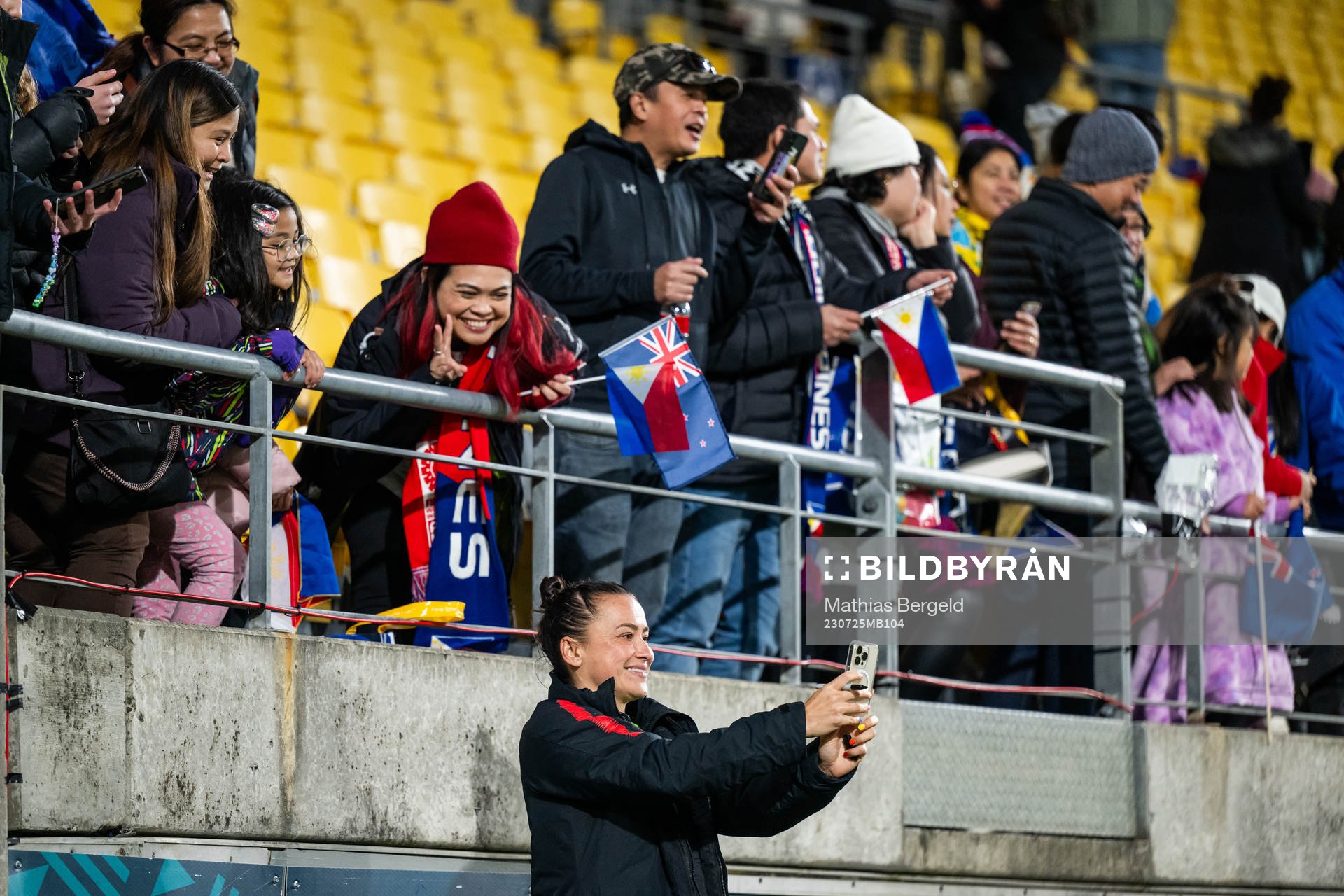 Ali Riley of New Zealand takes pictures with spectators