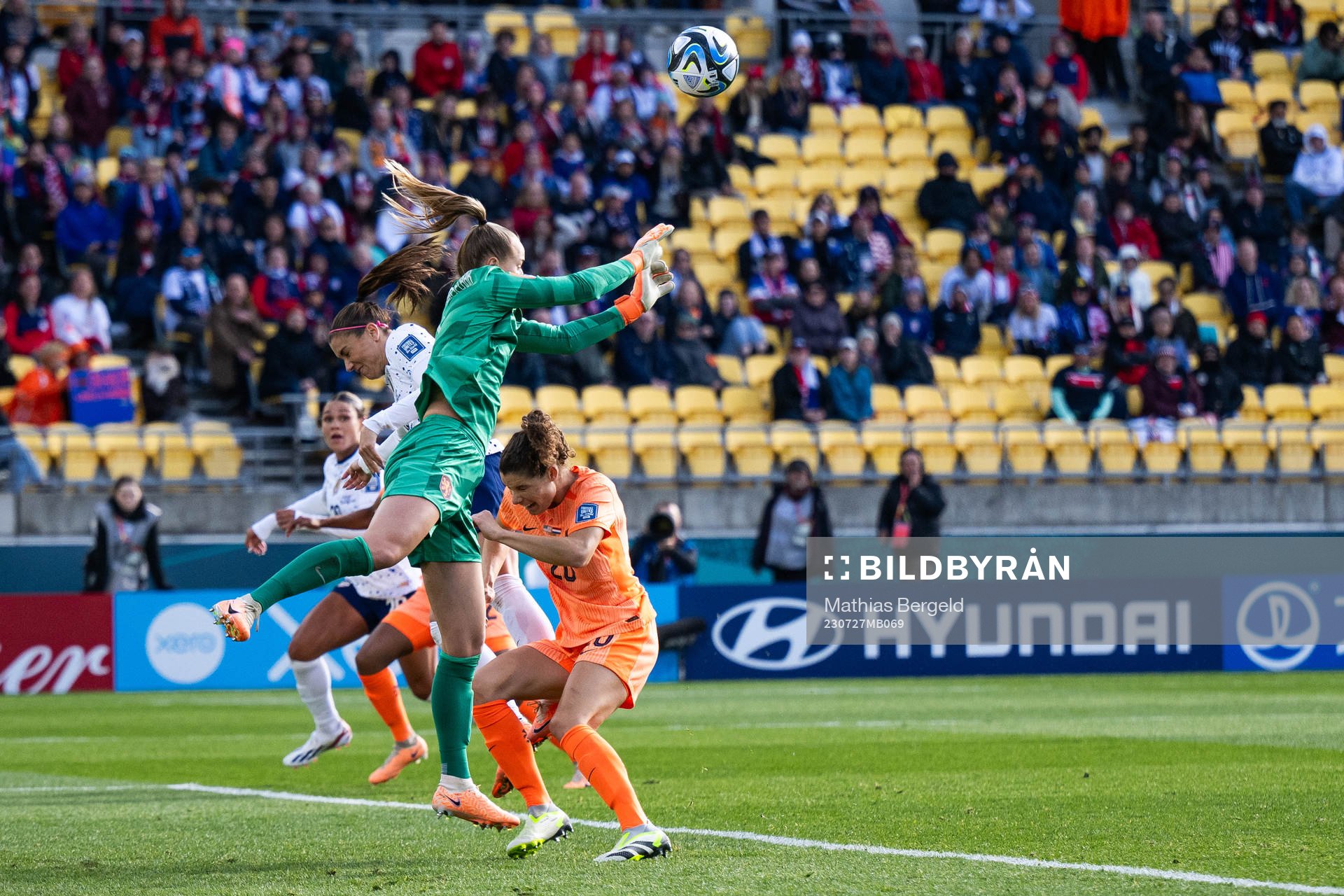 Alex Morgan of USA competes for the ball with goalkeeper