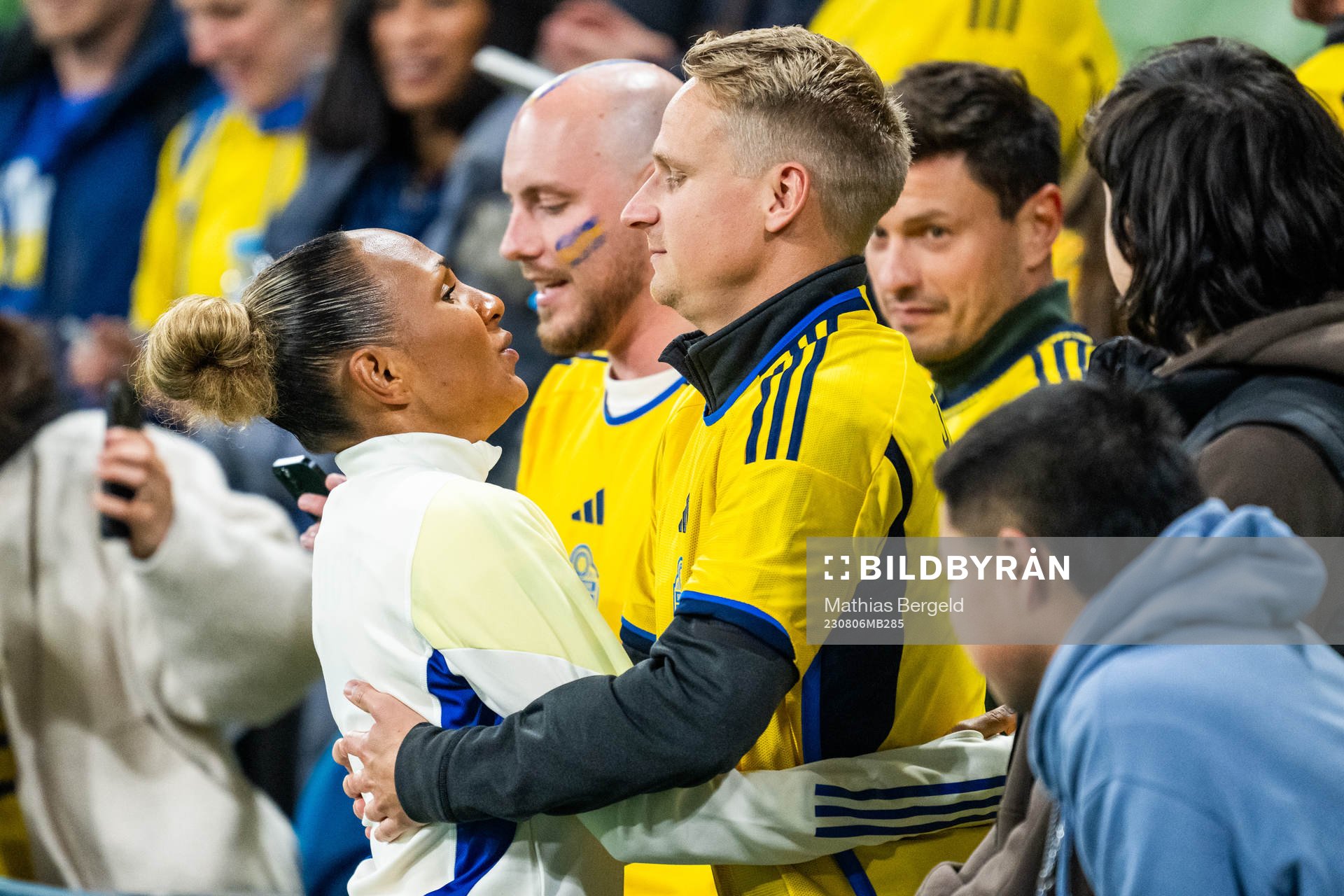 Madelen Janogy of Sweden hugs a man in the stands