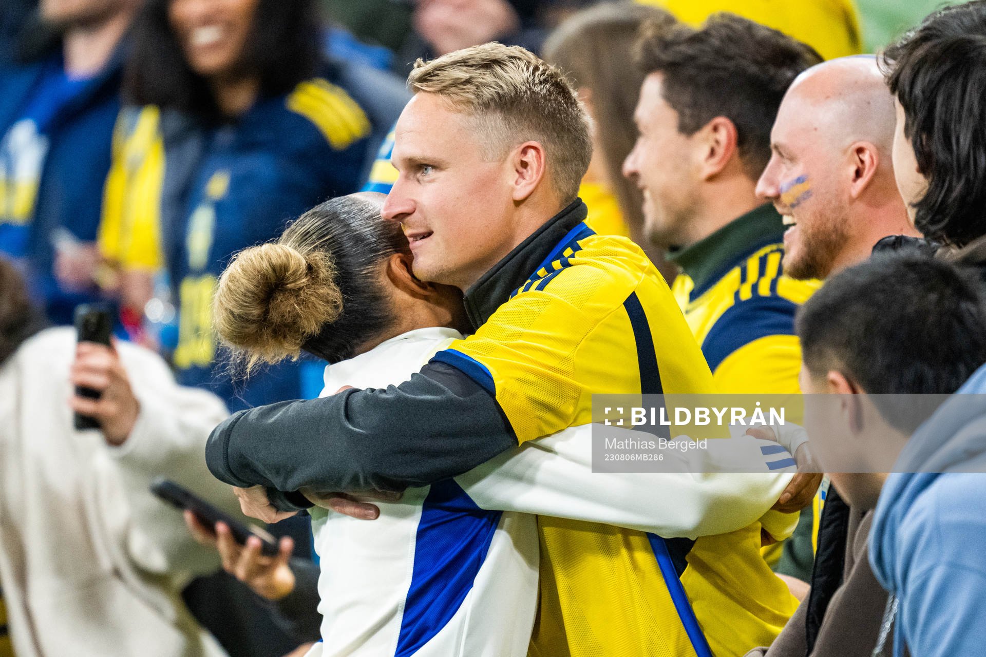 Madelen Janogy of Sweden hugs a man in the stands