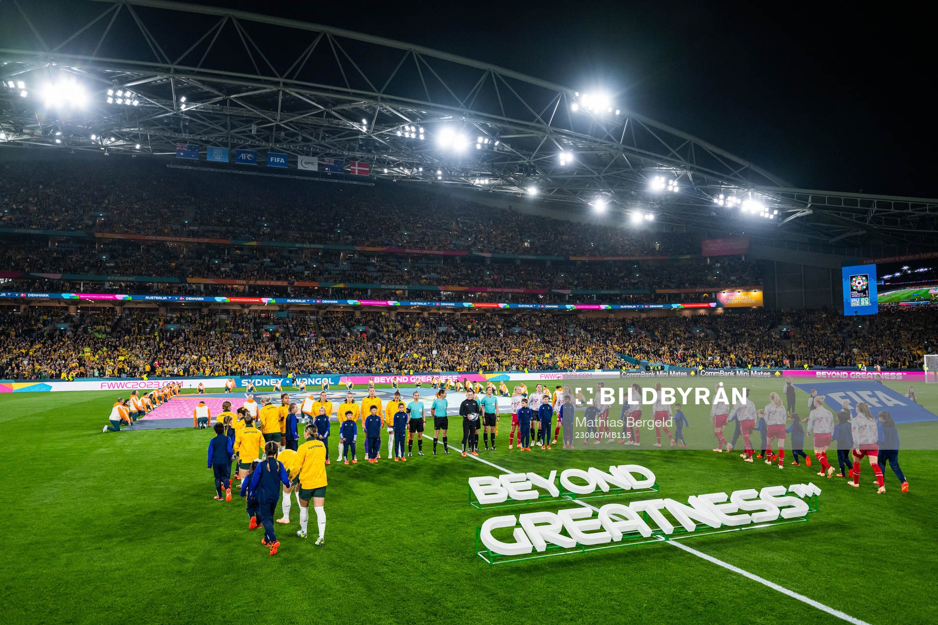 Players of Australia and of Denmark enter the pitch