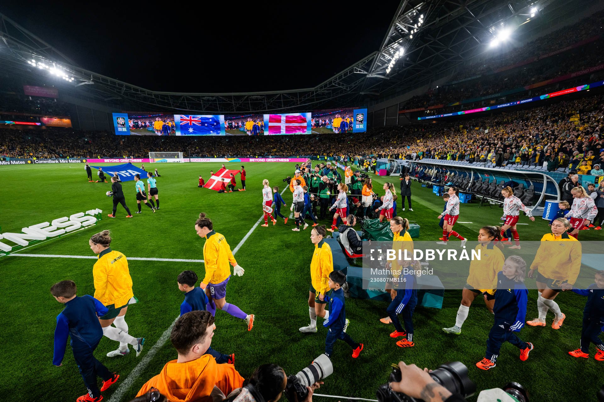 Players of Australia and of Denmark enter the pitch