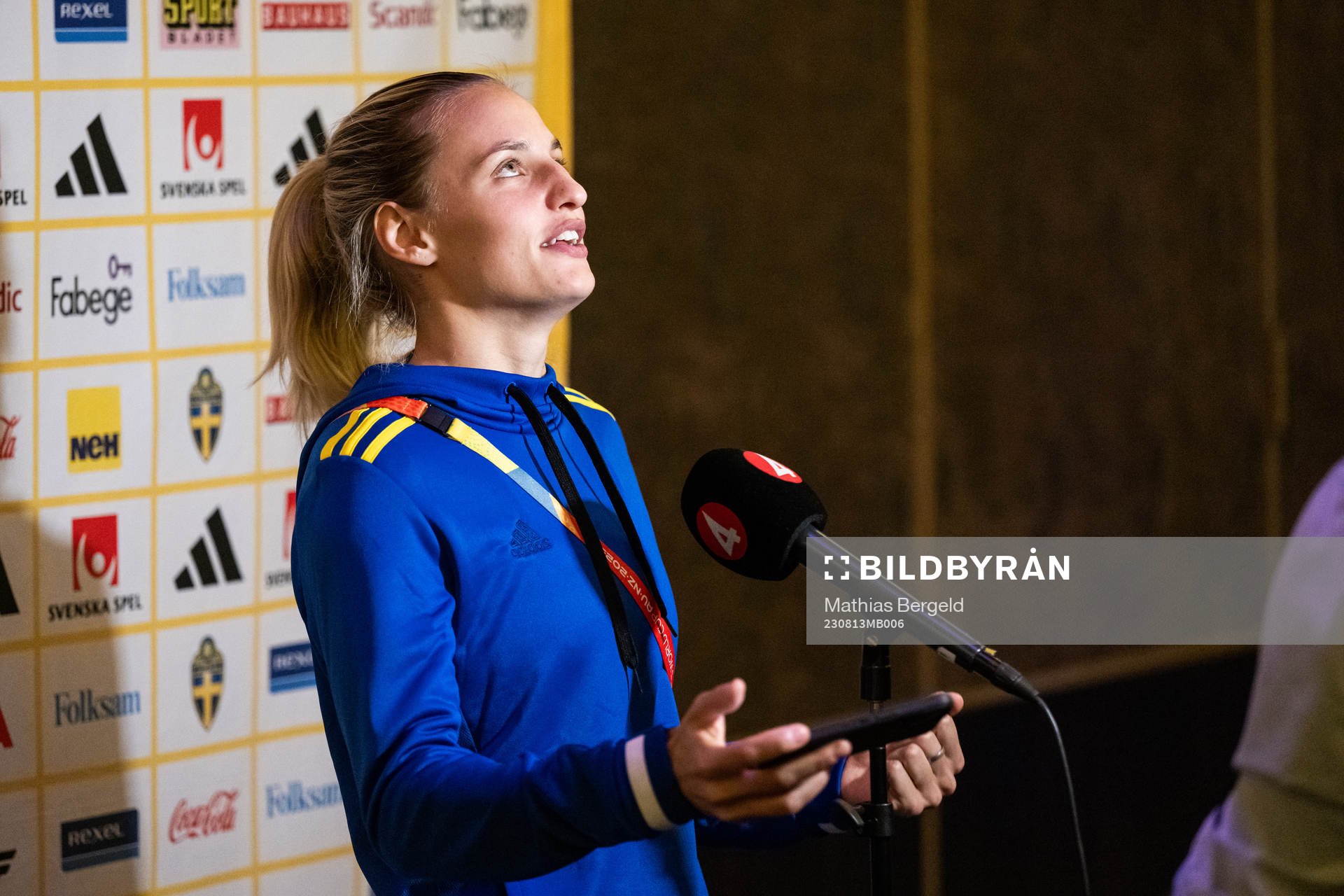 Nathalie Björn of the Swedish women's national football team is interviewed and reacts after being showed something on a mobile phone at a press event during the FIFA Women's World Cup on August 13, 2023 in Auckland. 