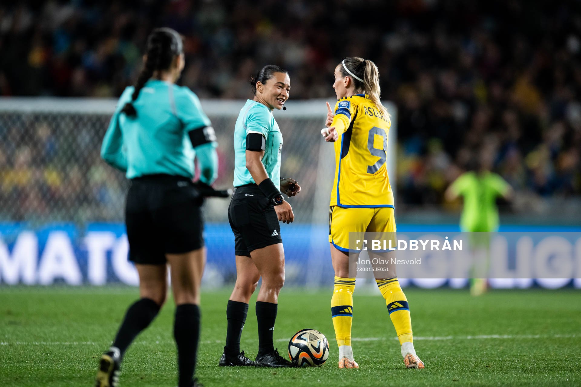 referee Edina Alves and Kosovare Asllani of Sweden