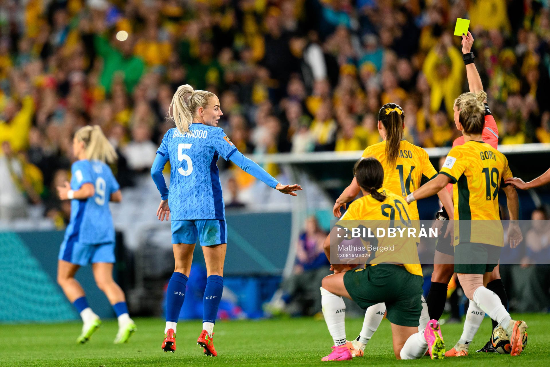 Alex Greenwood of England receives a yellow card