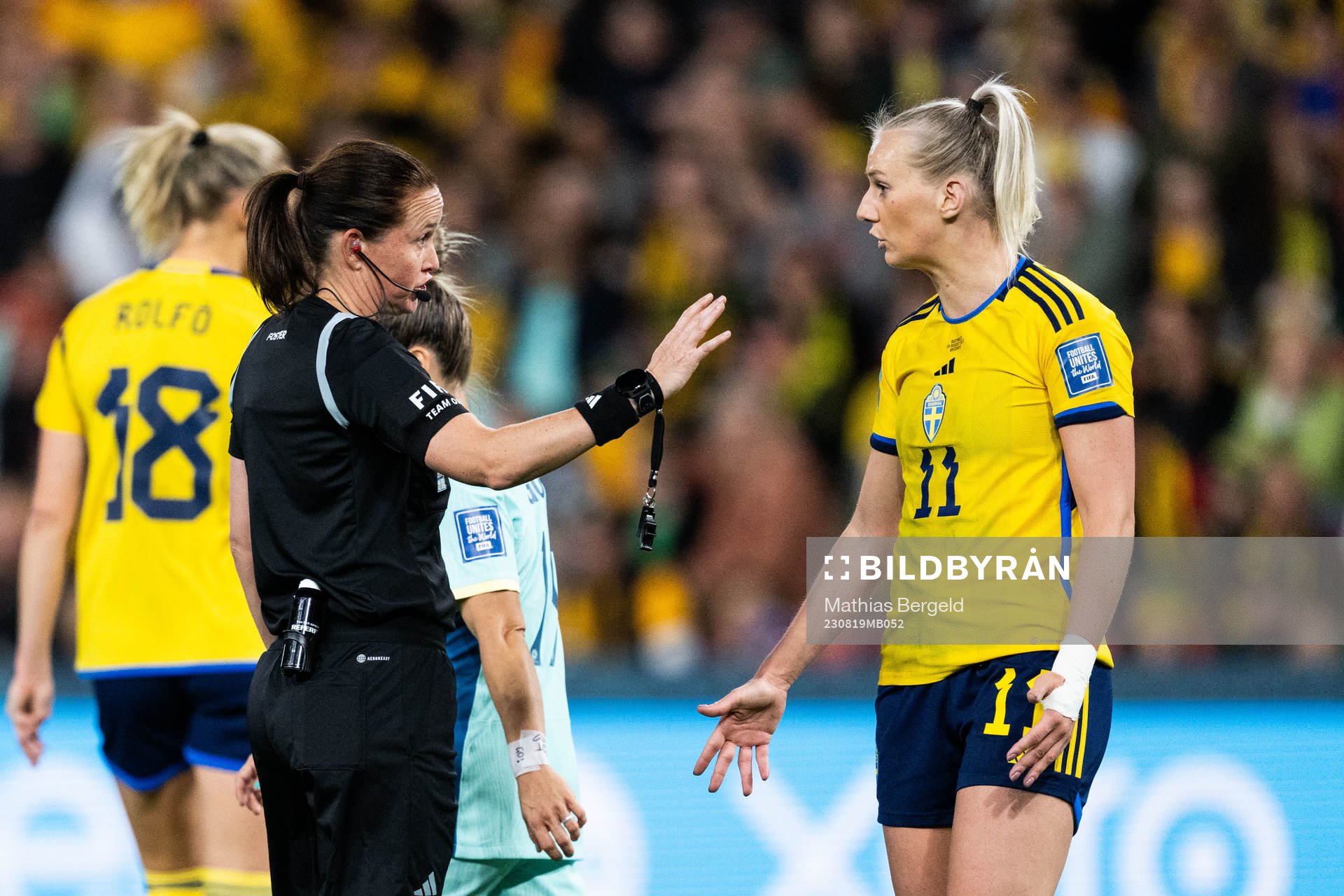 Referee Cheryl Foster and Stina Blackstenius of Sweden