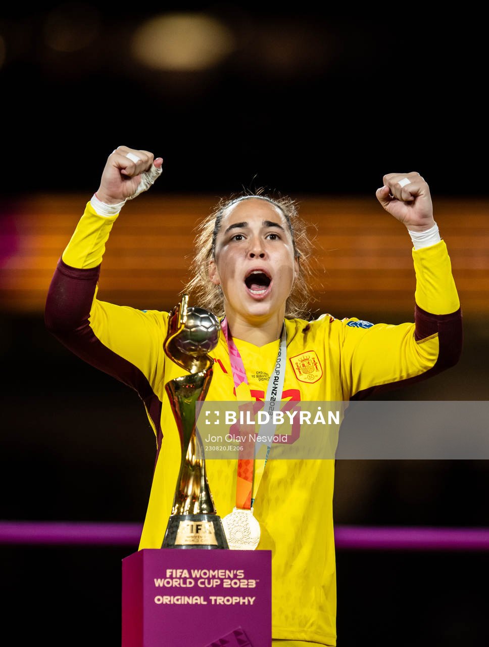 Goalkeeper Cata Coll of Spain celebrates with the trophy