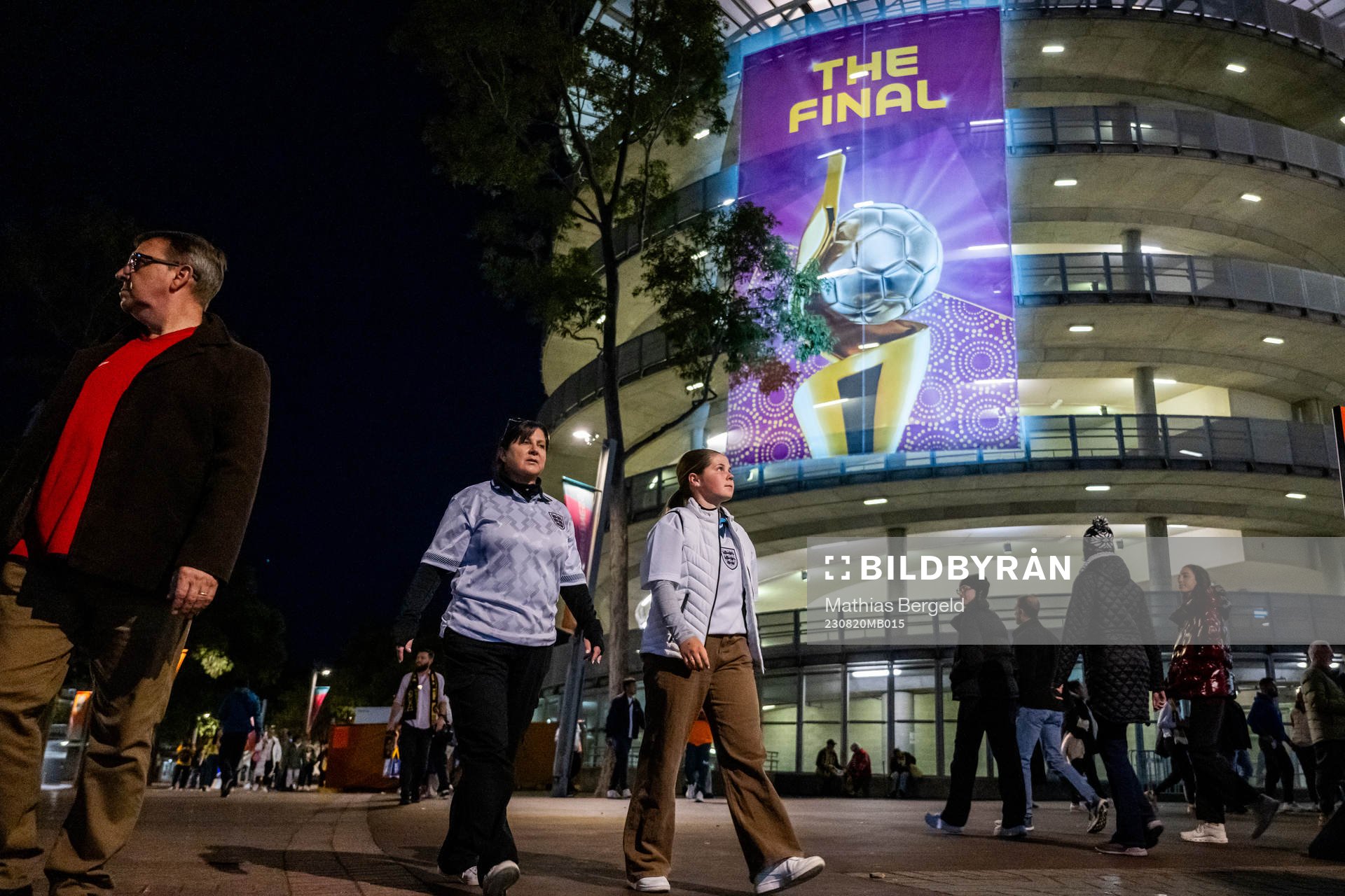 Spectators walk by a sign that reads ”The Final” is