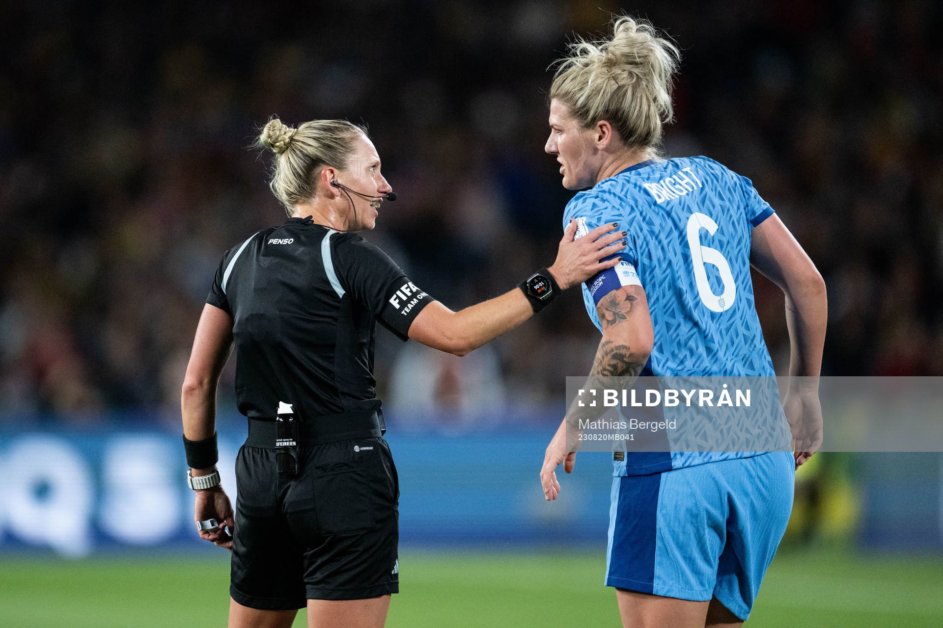 Referee Tori Penso and Millie Bright of England