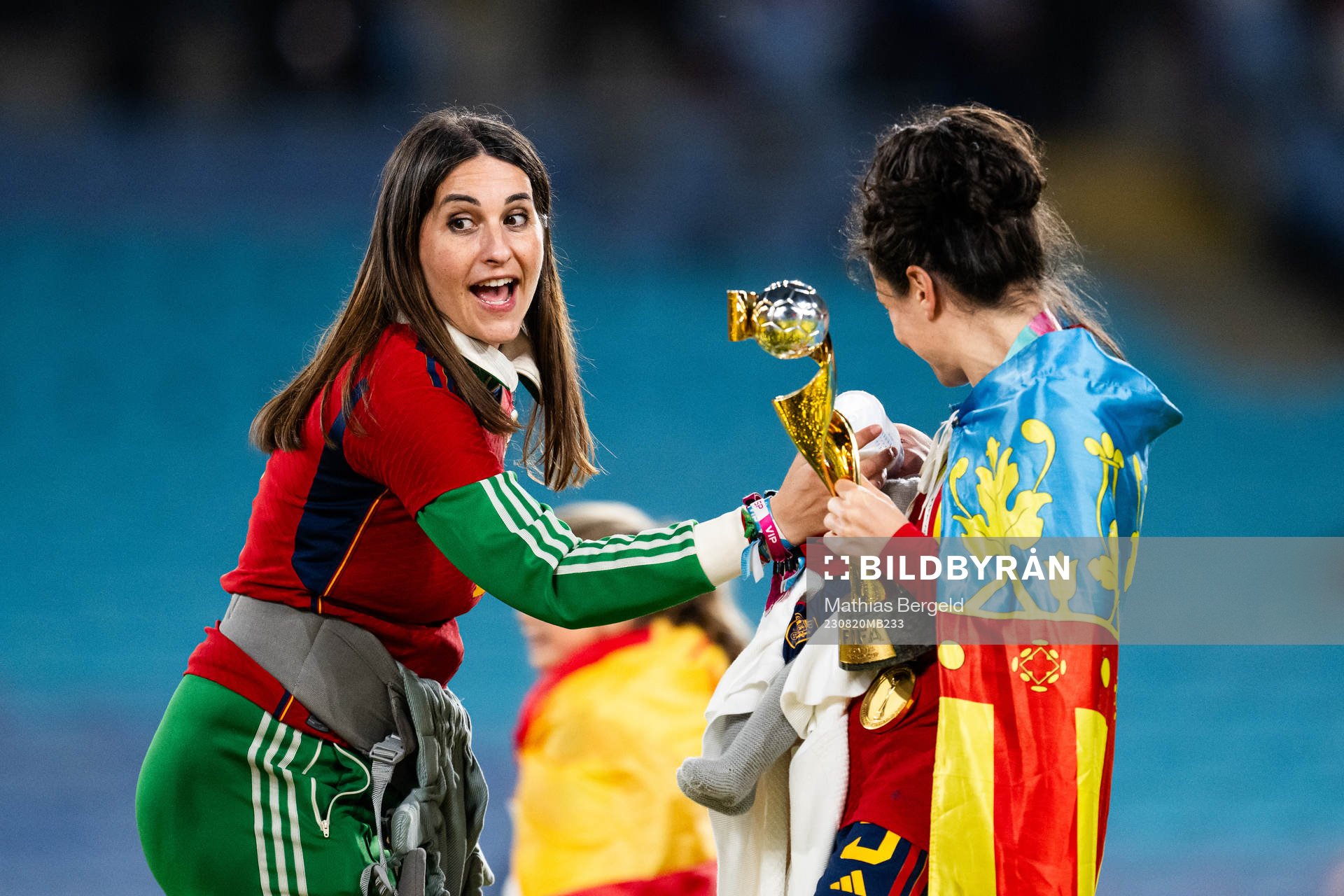 Ivana Andres of Spain holds a child that is being bottle