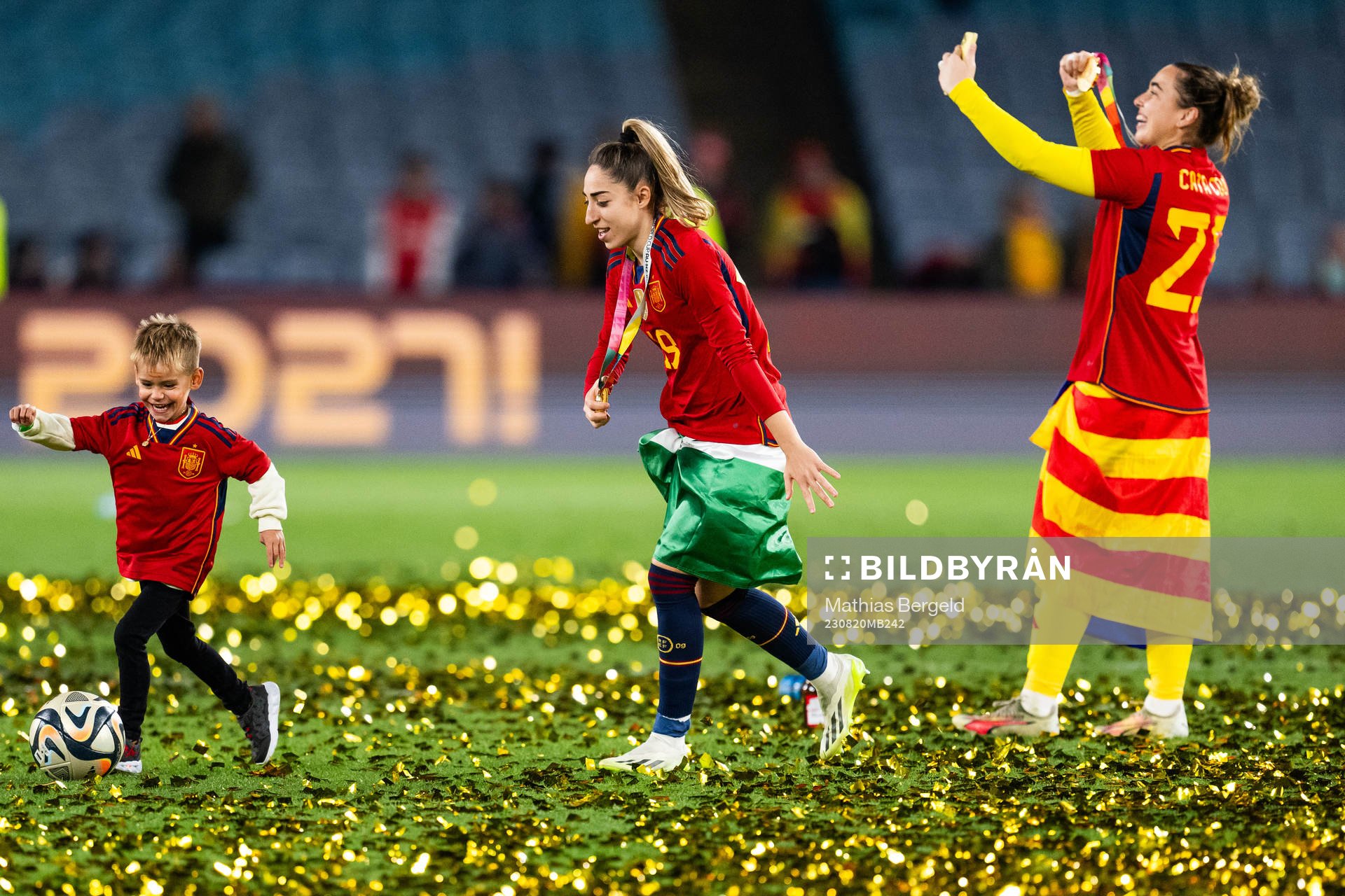 Olga Carmona of Spain plays football with a child as she