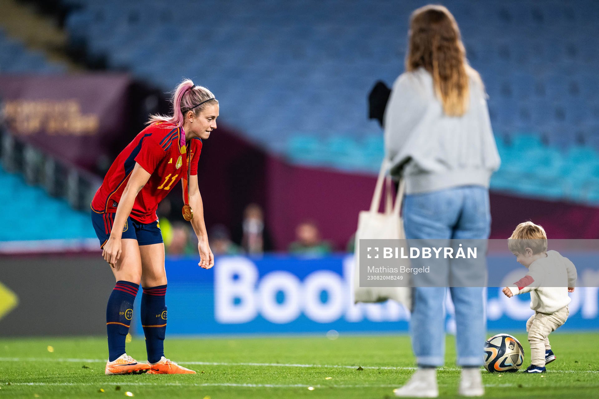 Alexia Putellas of Spain plays football with a child