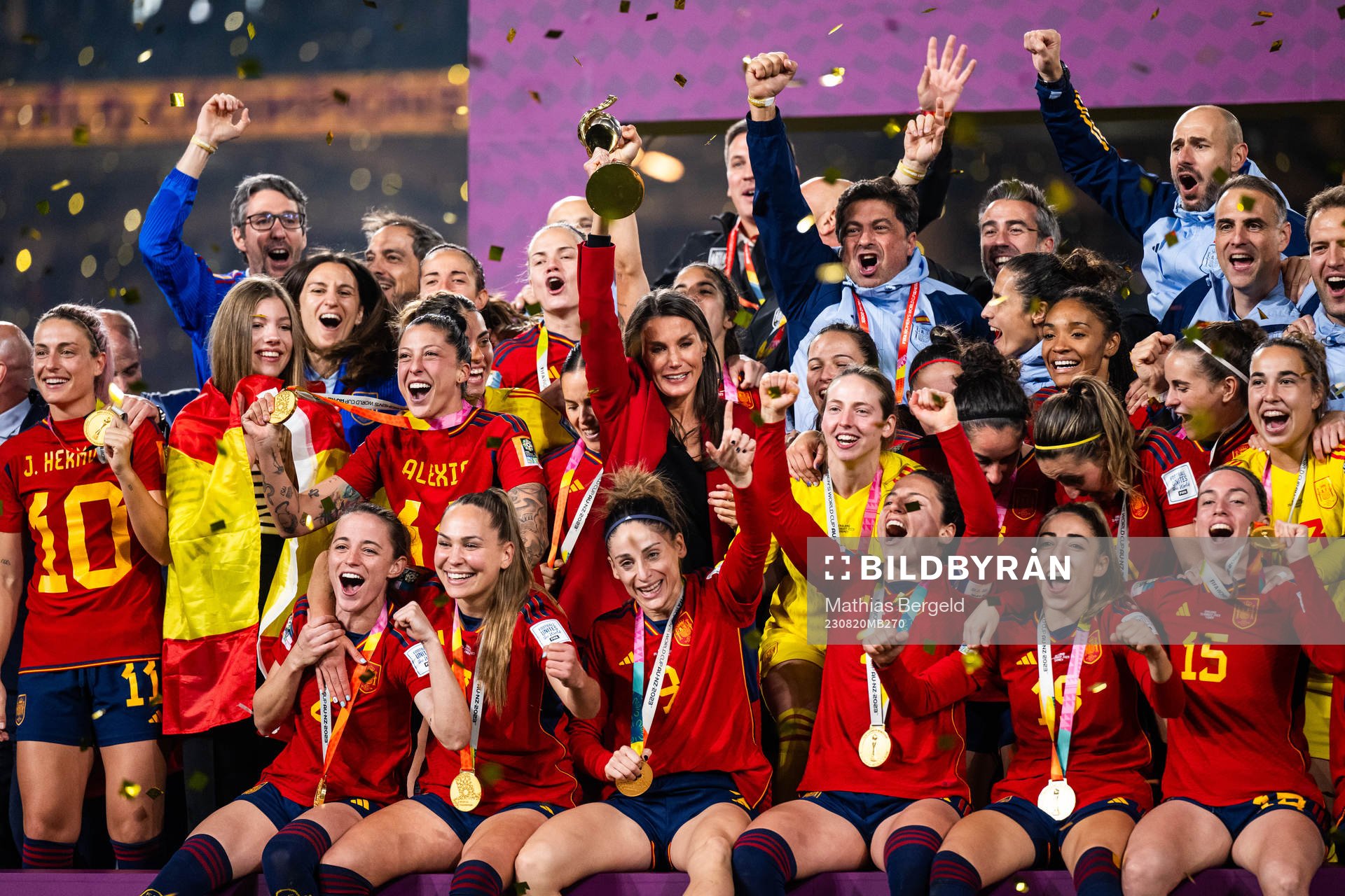 Queen Letizia of Spain celebrates with the trophyand players