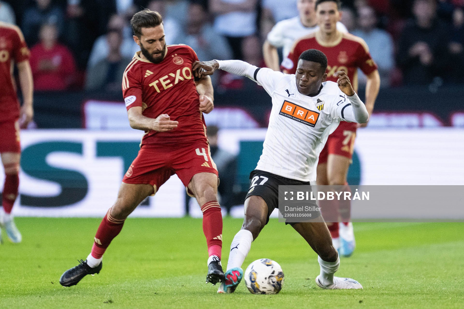Graeme Shinnie of Aberdeen and Akoua Romeo Amane of Häcken