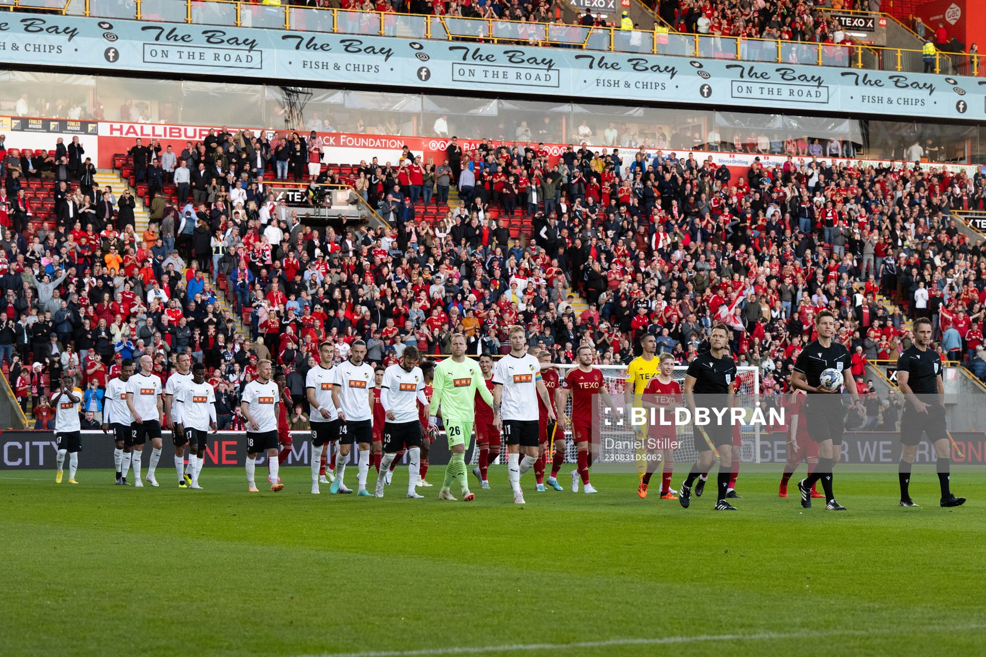 The players enter the pitch ahead of the UEFA Europa League play-off between Aberdeen and Häcken on August 31, 2023 in Aberdeen.
