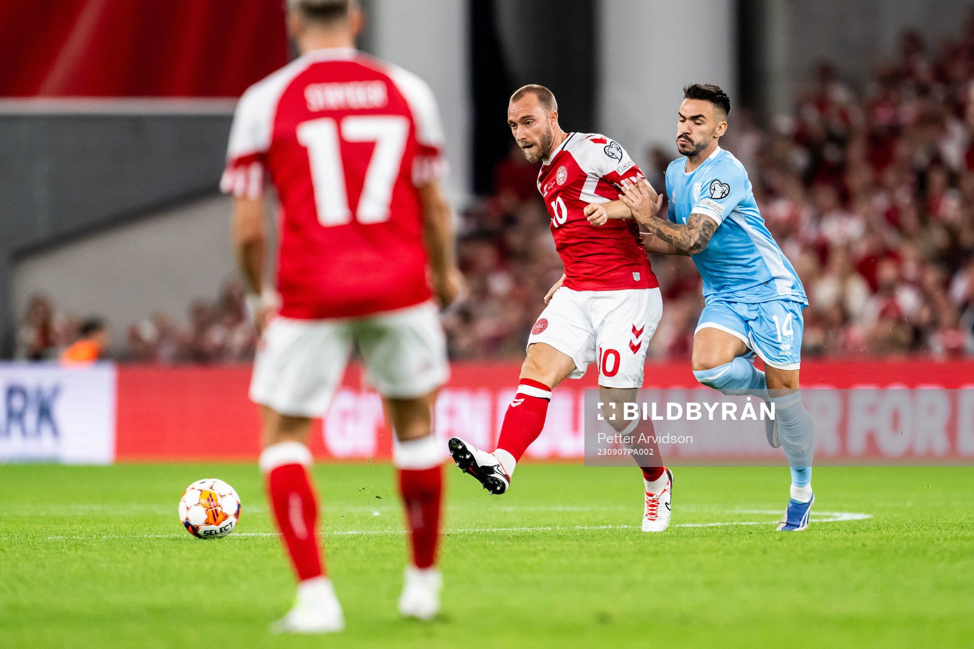 Christian Eriksen of Denmark and Fabio Tomassini  of San