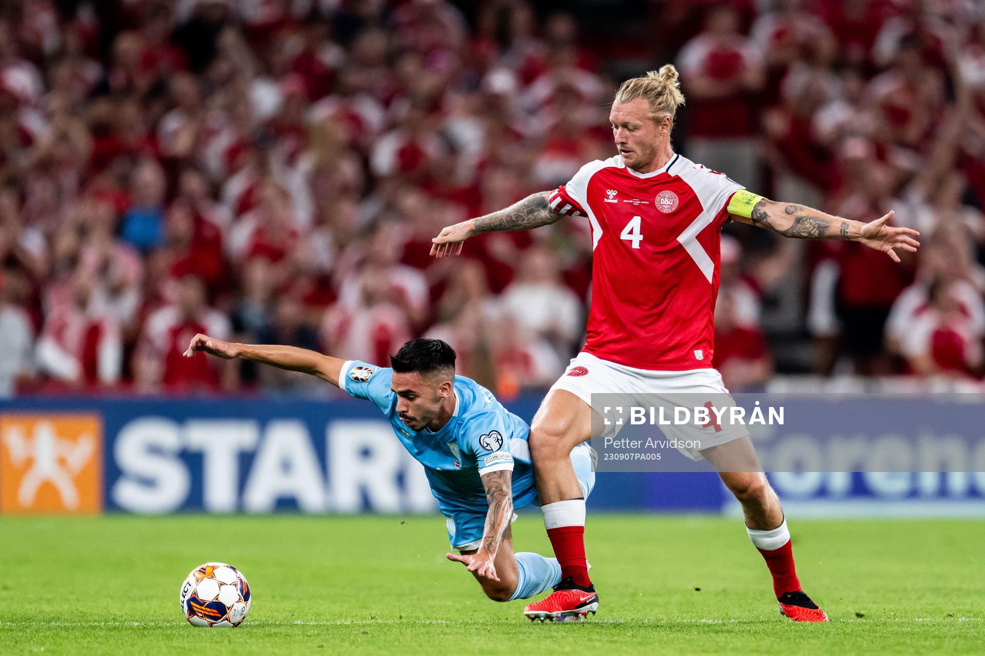Fabio Tomassini of San Marino and Simon Kjær of Denmark