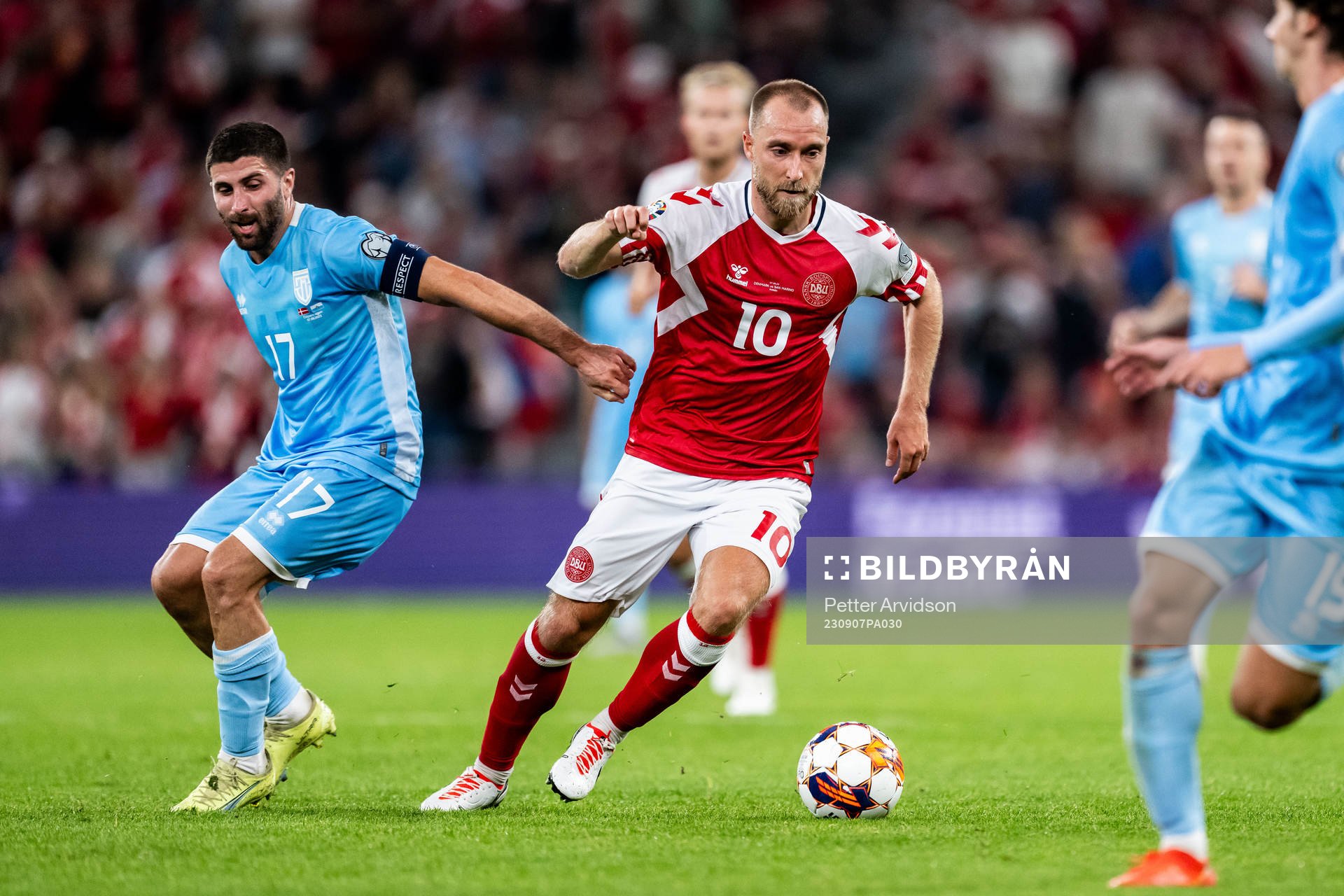Alessandro Golinucci of San Marino and Christian Eriksen of