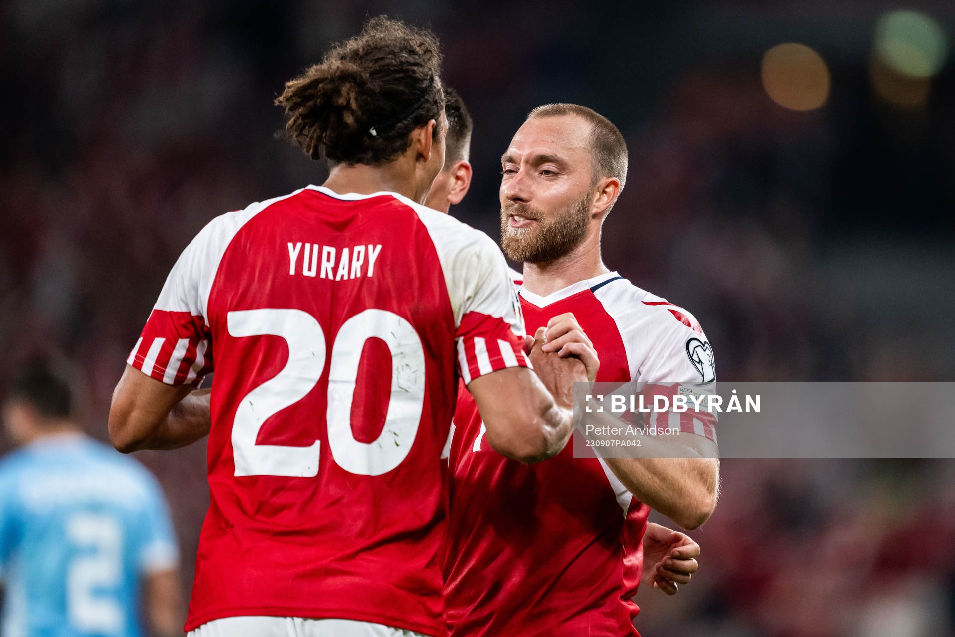 Yussuf Poulsen of Denmark celebrates with Christian Eriksen