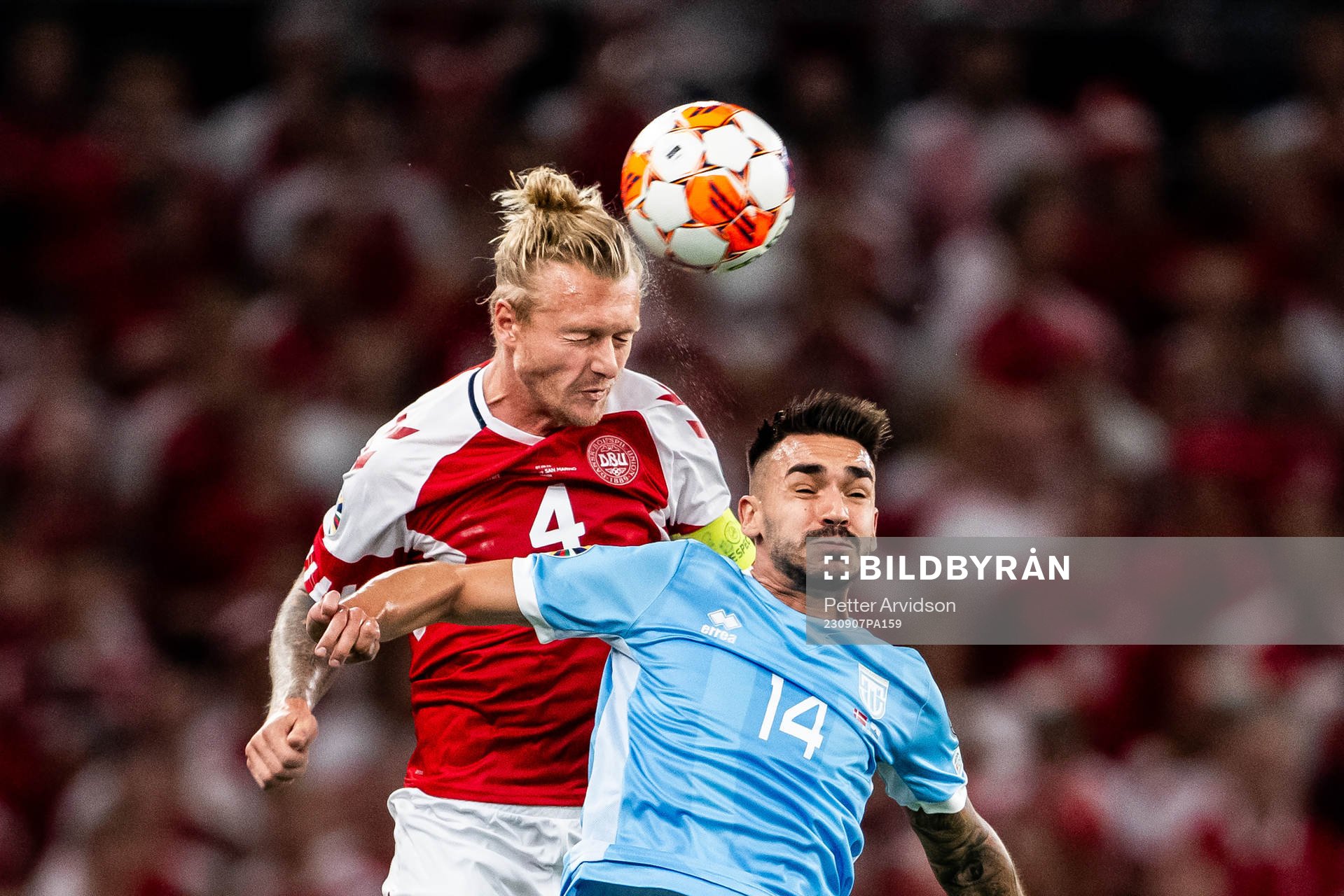 Simon Kjær of Denmark and Fabio Tomassini of San Marino