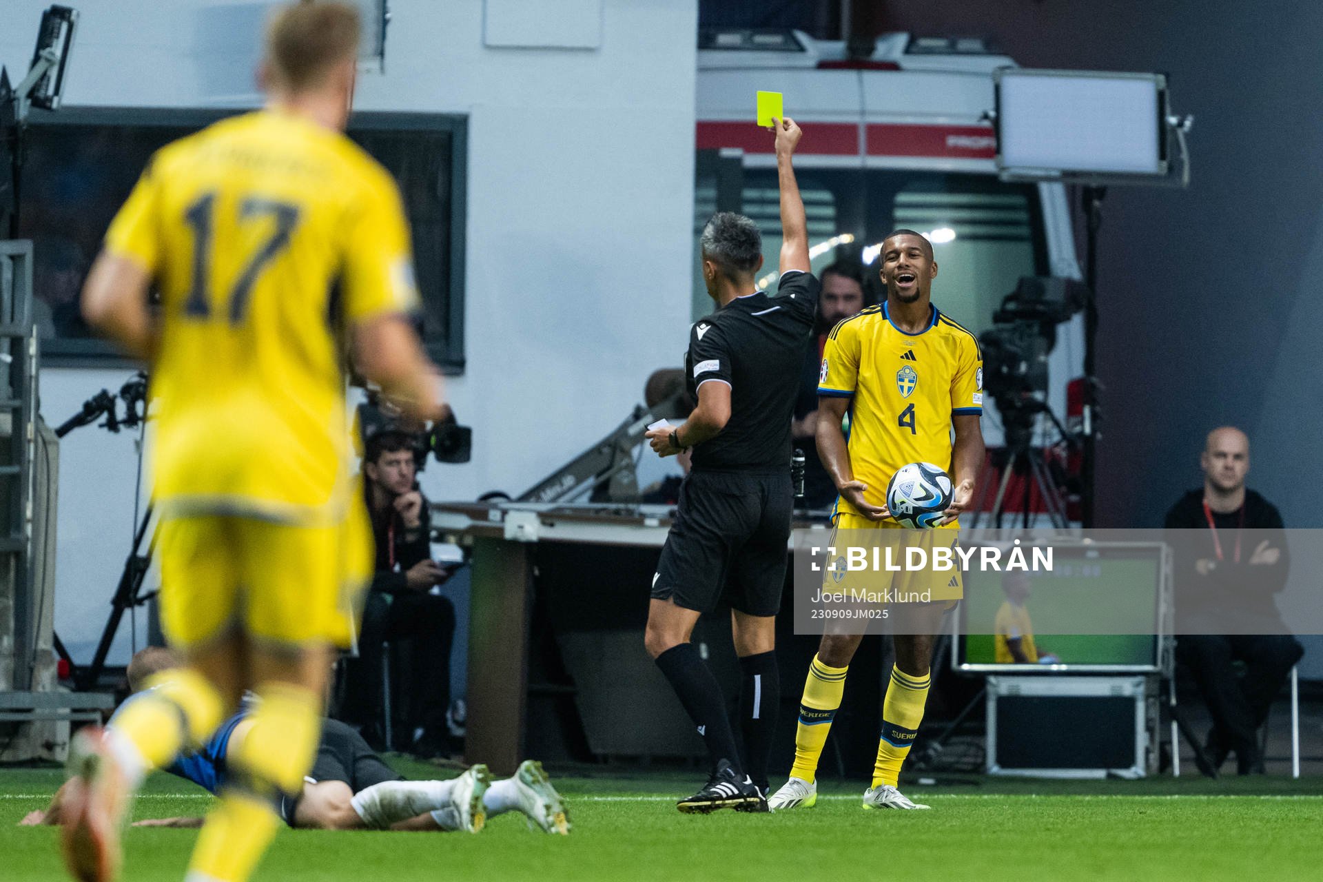 Isak Hien of Sweden is shown a yellow card by referee