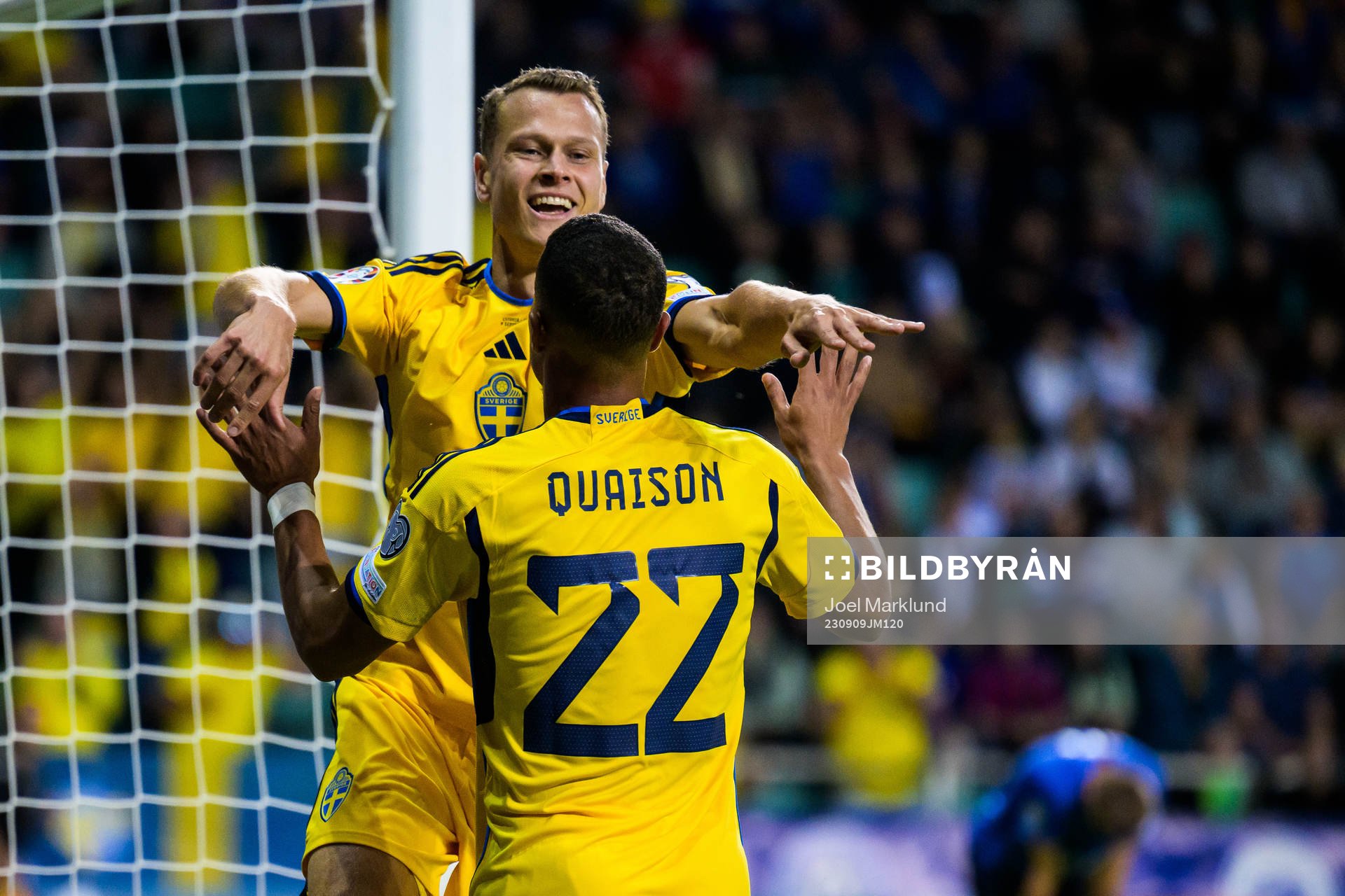 Viktor Claesson and Robin Quaison of Sweden celebrate the