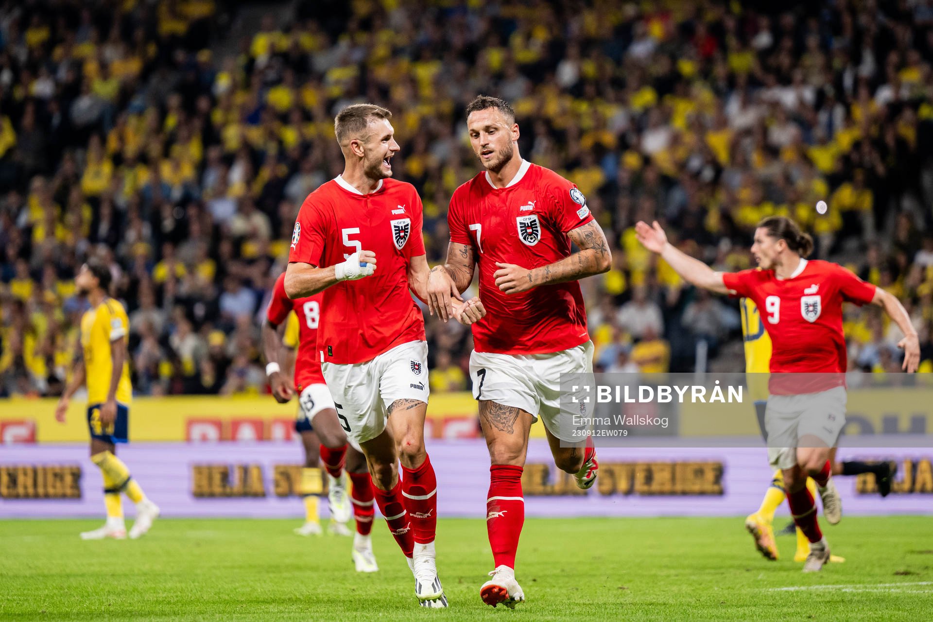 Stefan Posch and Marko Arnautovic of Austria celebrate