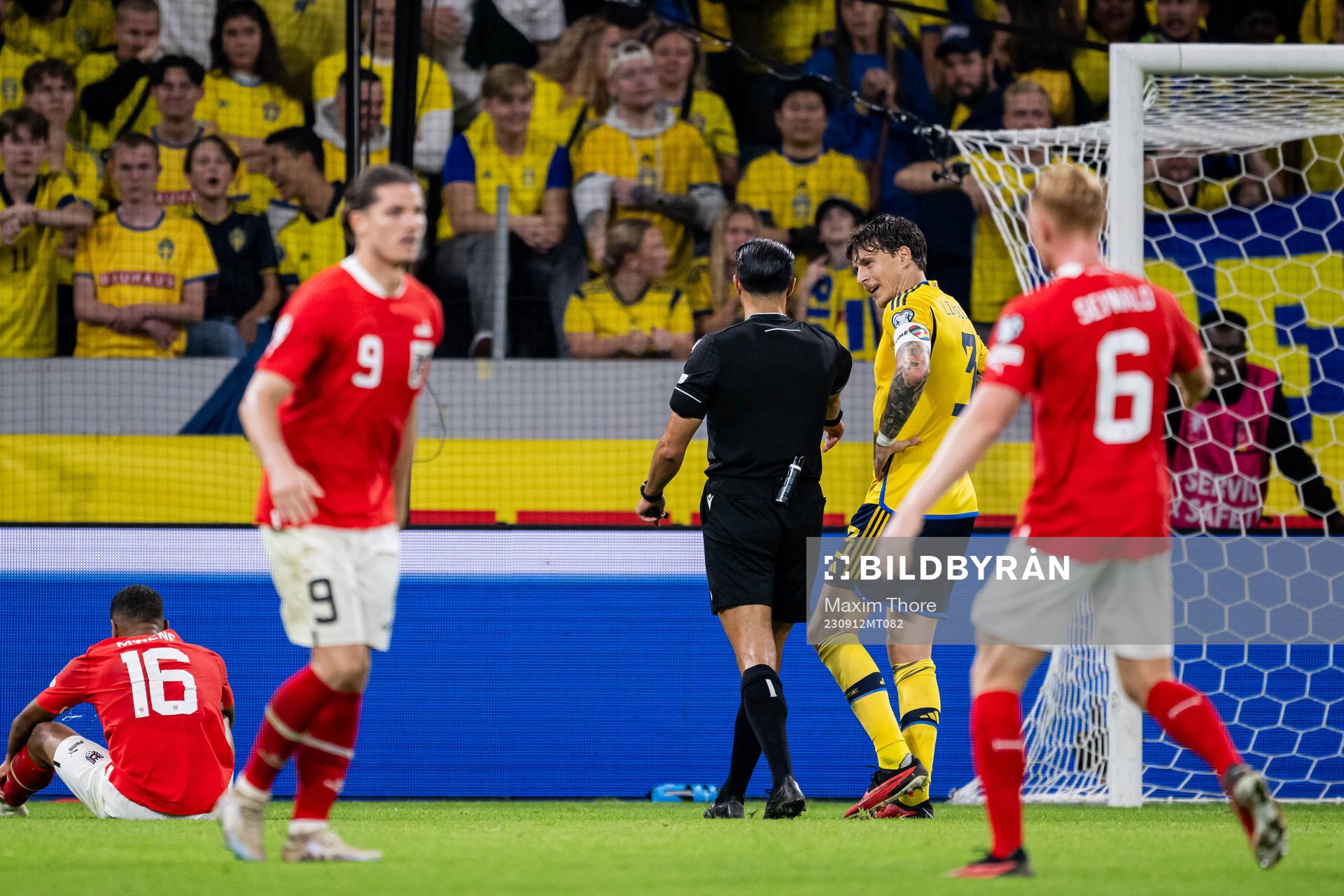 Victor Nilsson Lindelöf of Sweden and referee Serdar