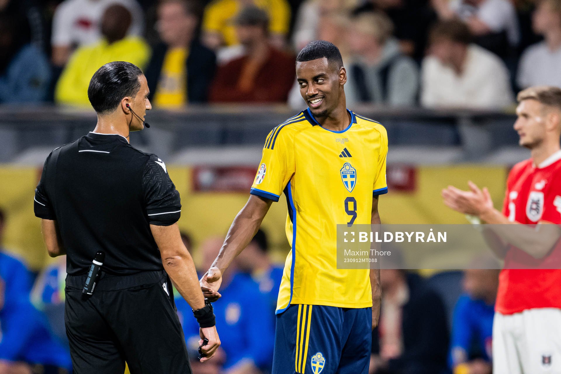 Referee Serdar Gozubuyuk and Alexander Isak of Sweden