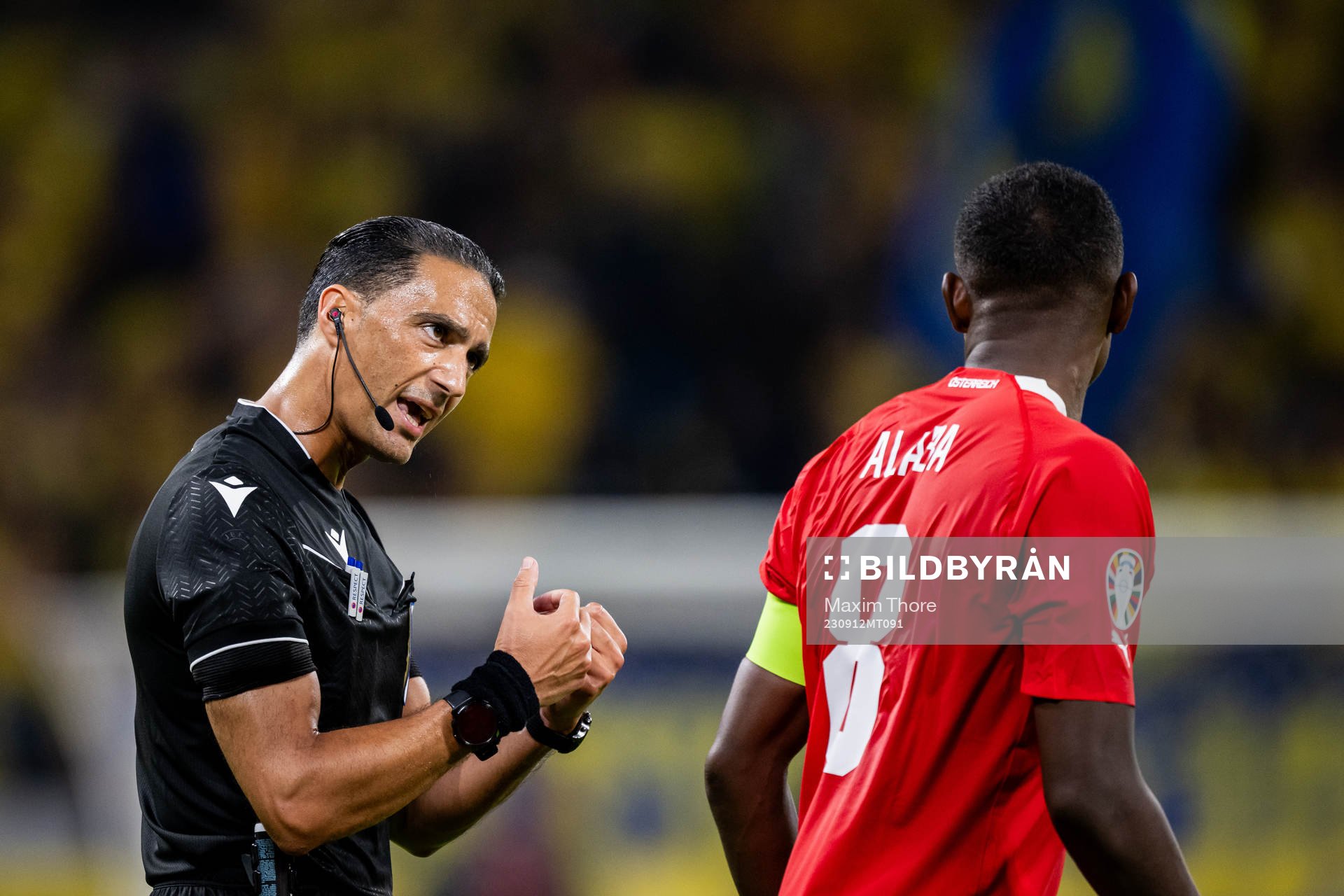 Referee Serdar Gozubuyuk and David Alaba of Austria