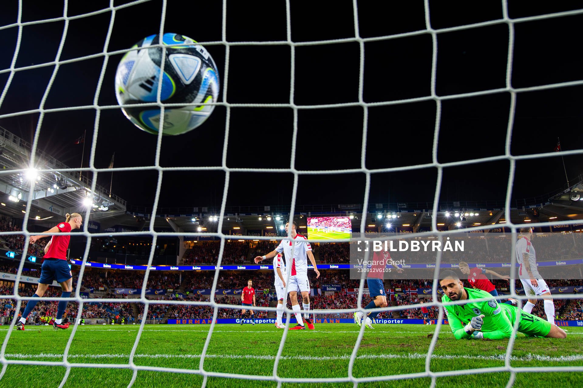 Martin Ødegaard of Norway scores 2-0 behind goalkeeper Giorgi Mamardashvili of Georgia during the UEFA Euro Qualifier football match between Norway and Georgia on September 12, 2023 in Oslo.