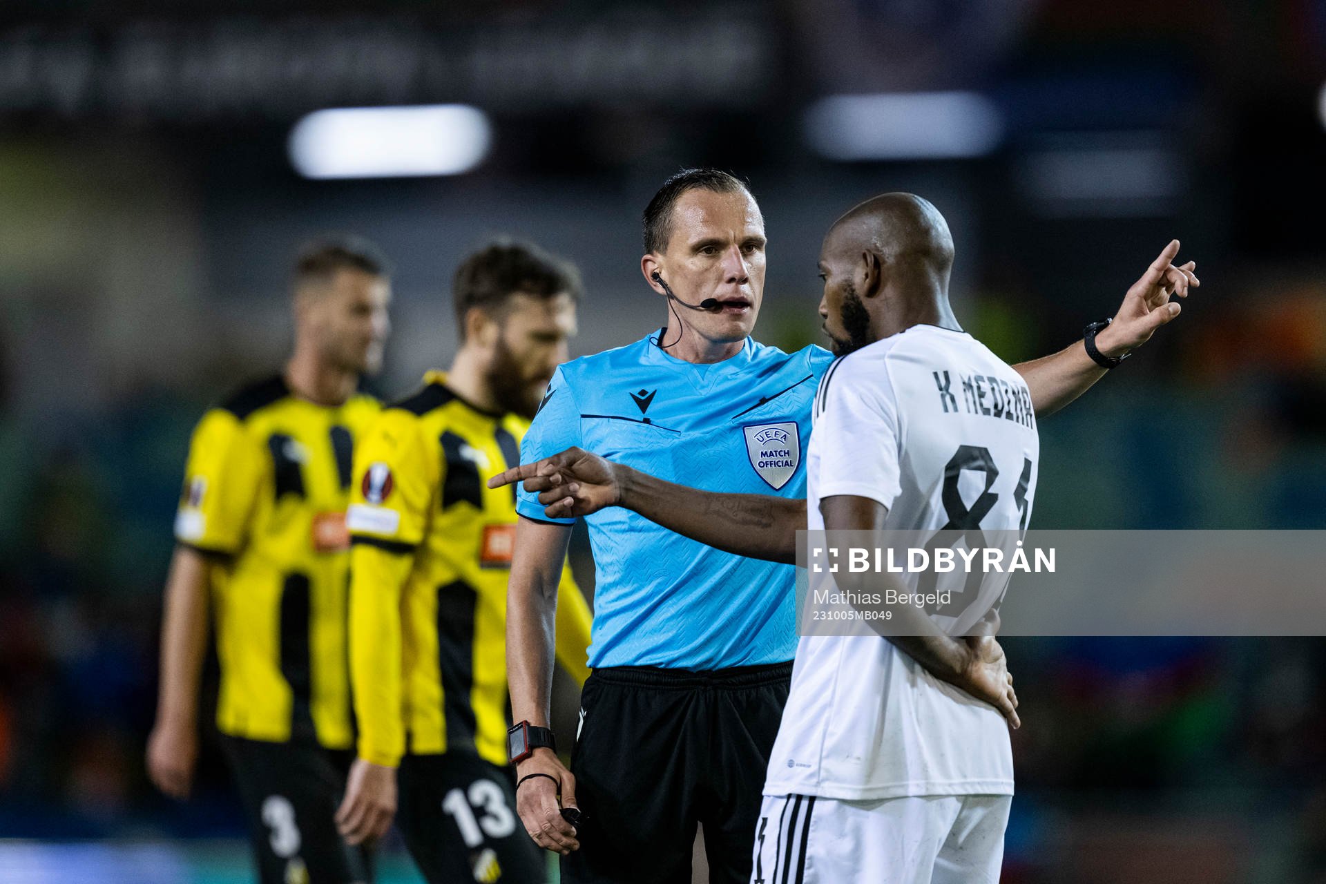 Referee Sebastian Gishamer and Kevin Medina of Qarabag